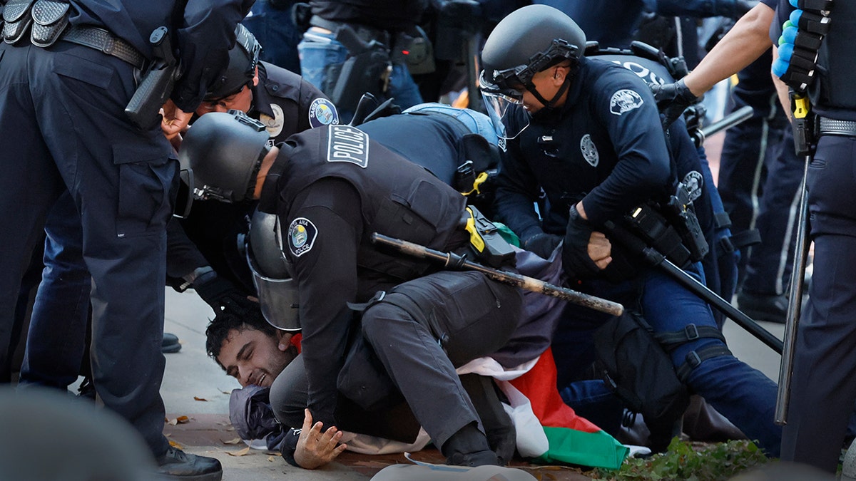 Police tackling protester