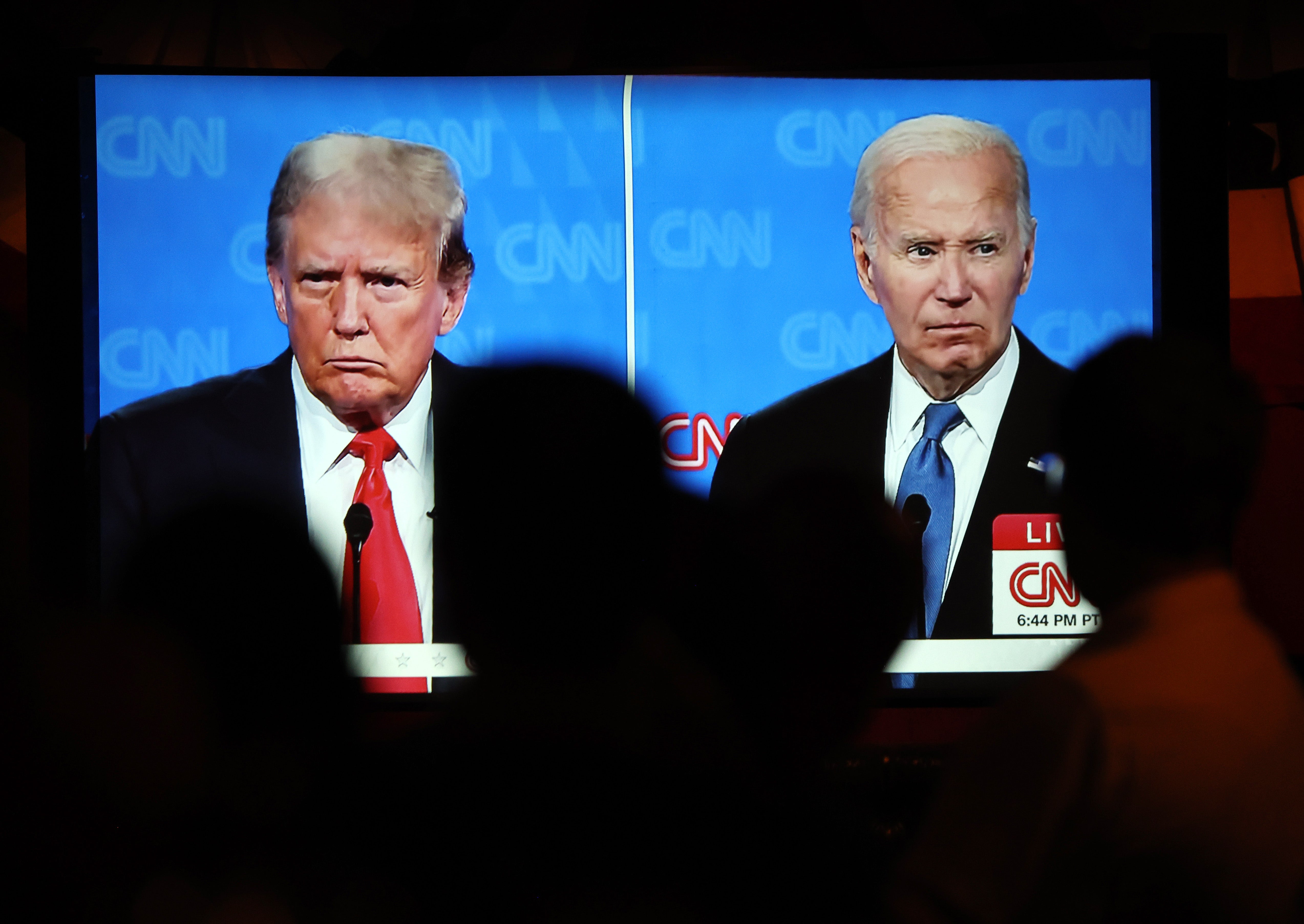 People watch the presidential debate between Joe Biden and Donald Trump at a watch party in Los Angeles, California