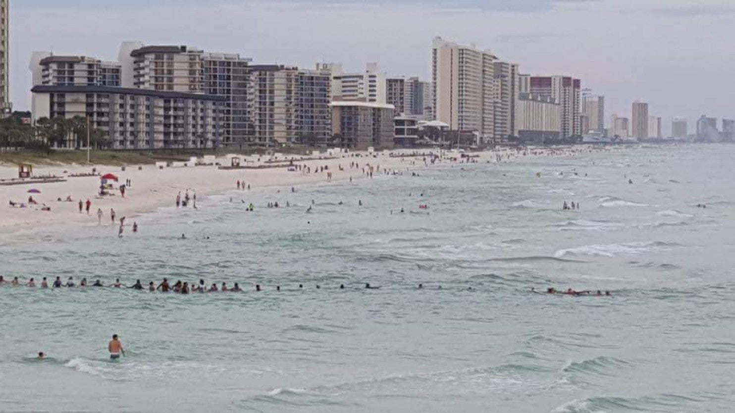 Dozens of beachgoers at Panama City Beach form a human chain to rescue nine stranded swimmers in August 2022