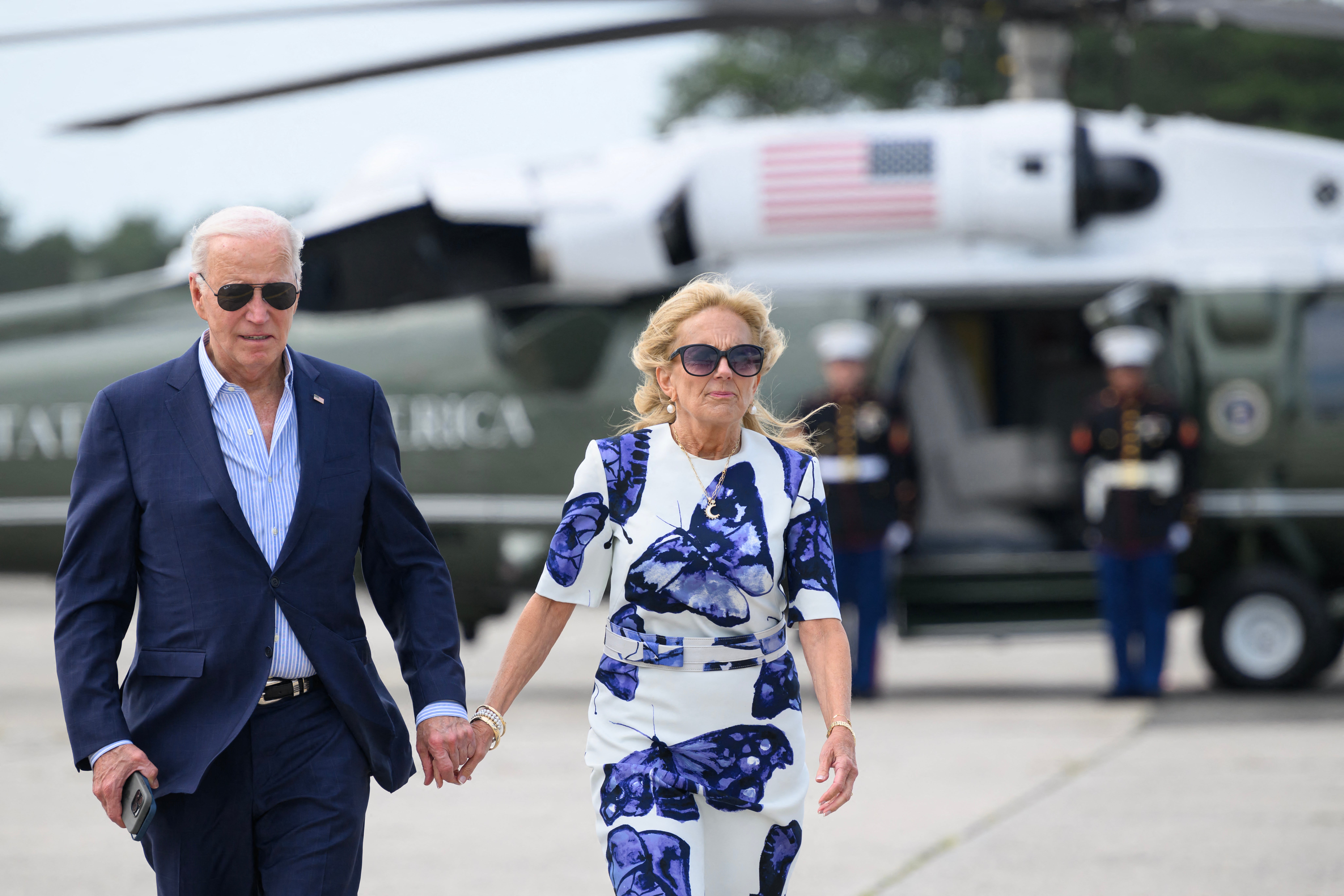US President Joe Biden and First Lady Jill Biden walk from Marine One to board Air Force One at Francis S. Gabreski Airport in Westhampton Beach, New York
