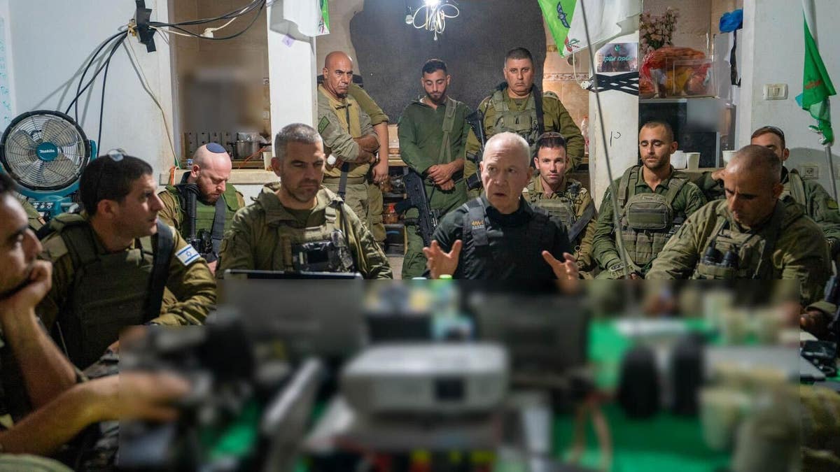 Israeli Defense Minister Yoav Gallant talks to members of the IDF Division 162 during a defense forces assessment.