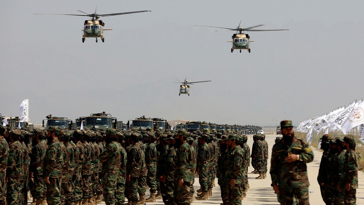 UH-60 Black Hawk helicopters fly during a military parade to mark the third anniversary of the withdrawal of U.S.-led troops from Afghanistan at Bagram Air Base in the Parwan Province of Afghanistan on Wednesday, Aug. 14, 2024.