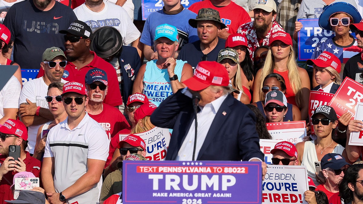 Donald Trump reacts as multiple shots rang out during a campaign rally at the Butler Farm Show