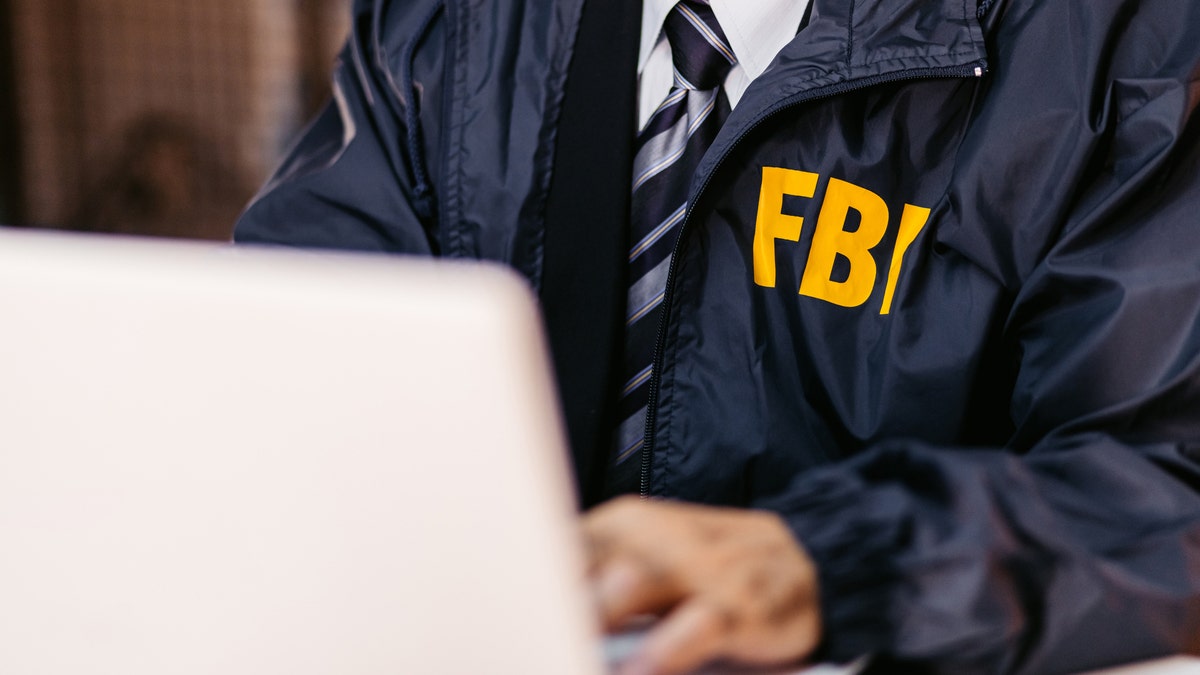 FBI detective on computer