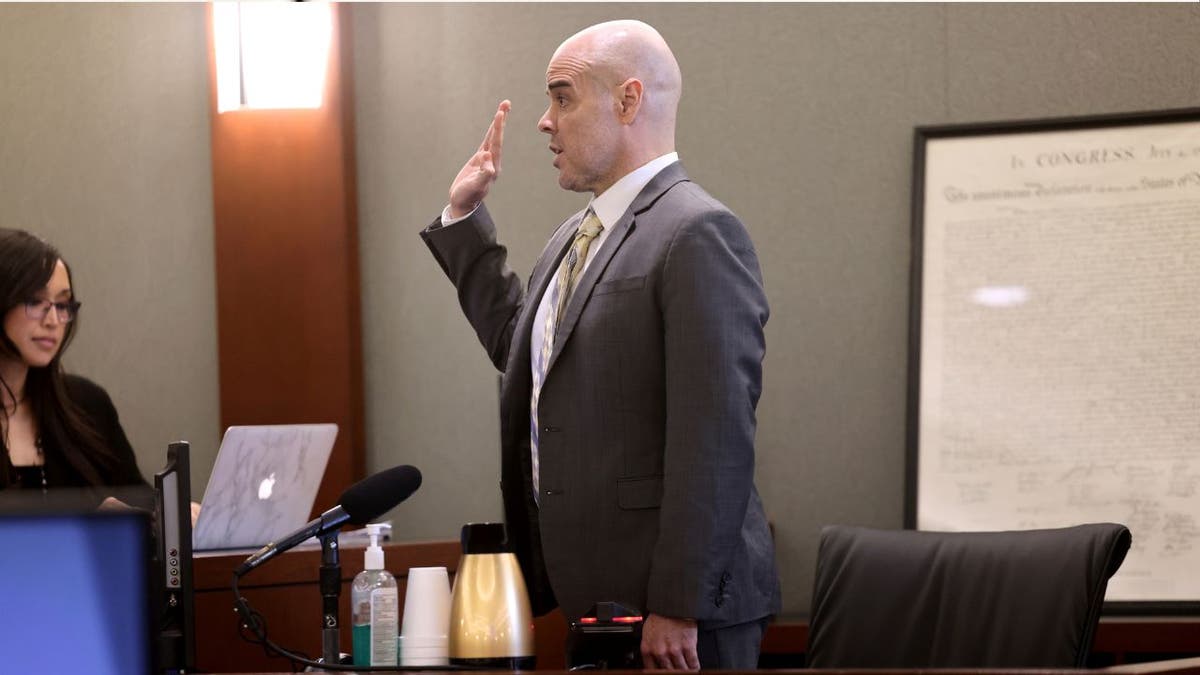 Robert Telles raises his right hand in court