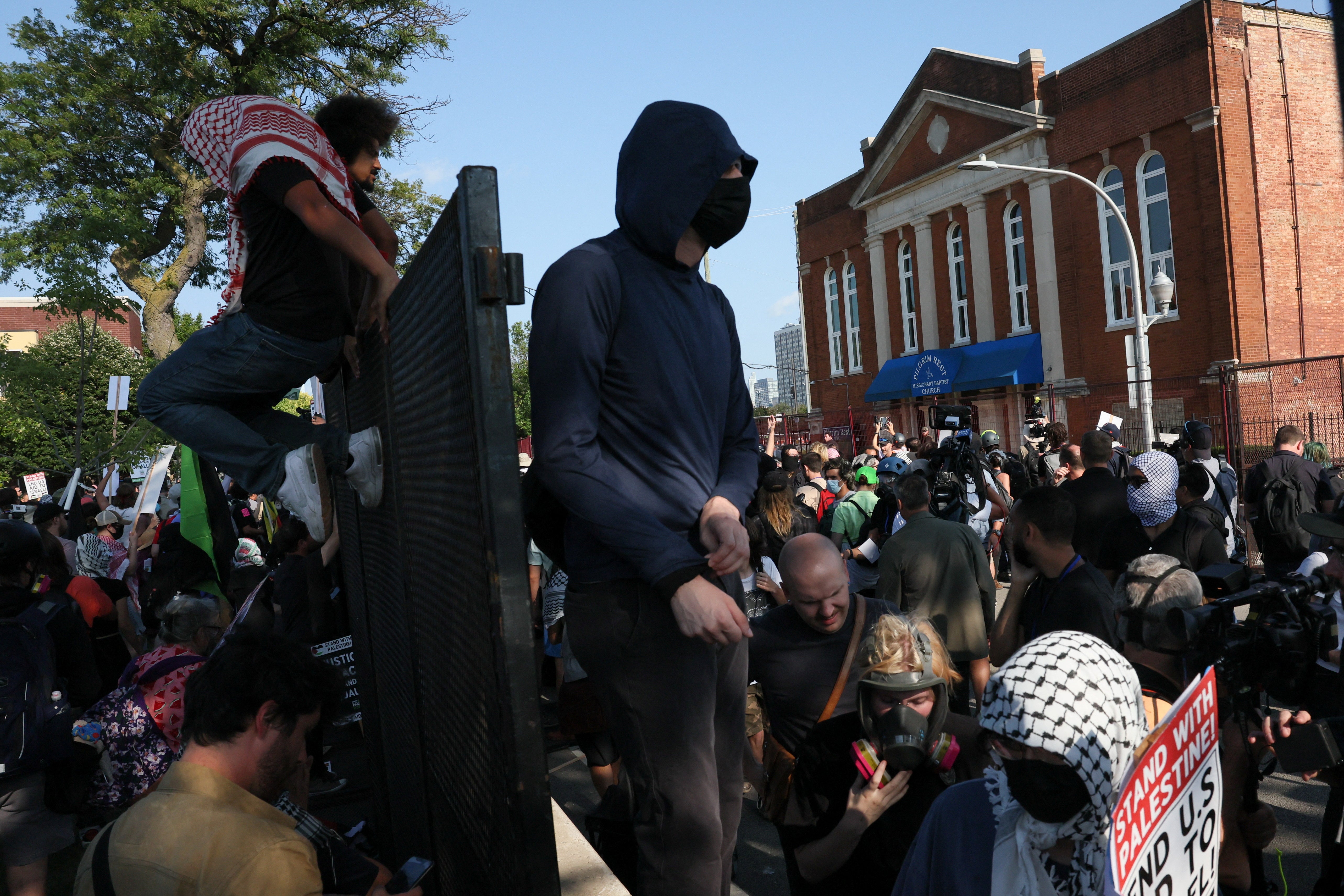 Some protesters, dressed in black with their faces covered, dragged pieces of the fence back to a park near the United Center, where the convention is being held