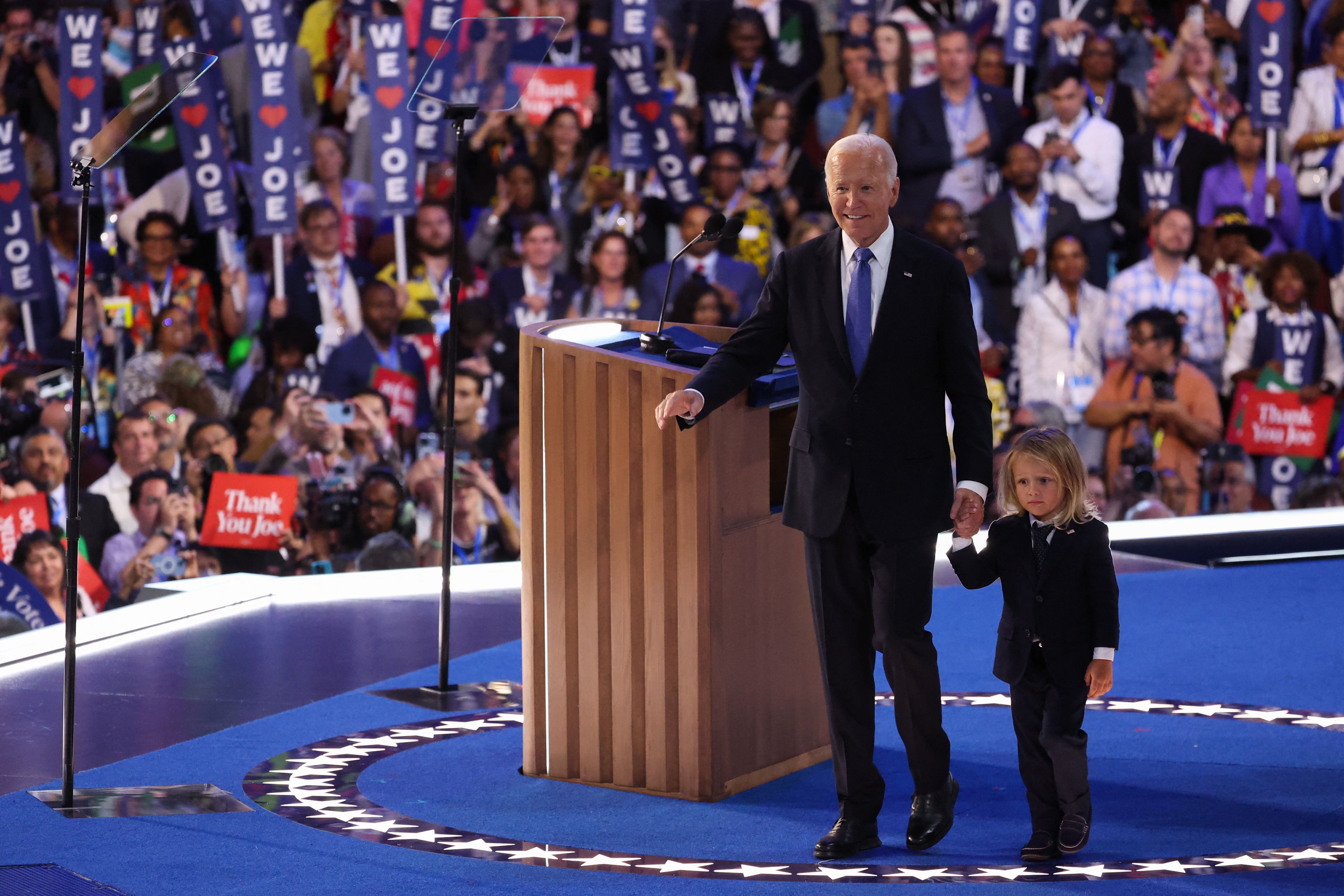 Joe Biden walks with his grandchild after his remarks to the Democratic National Convention.