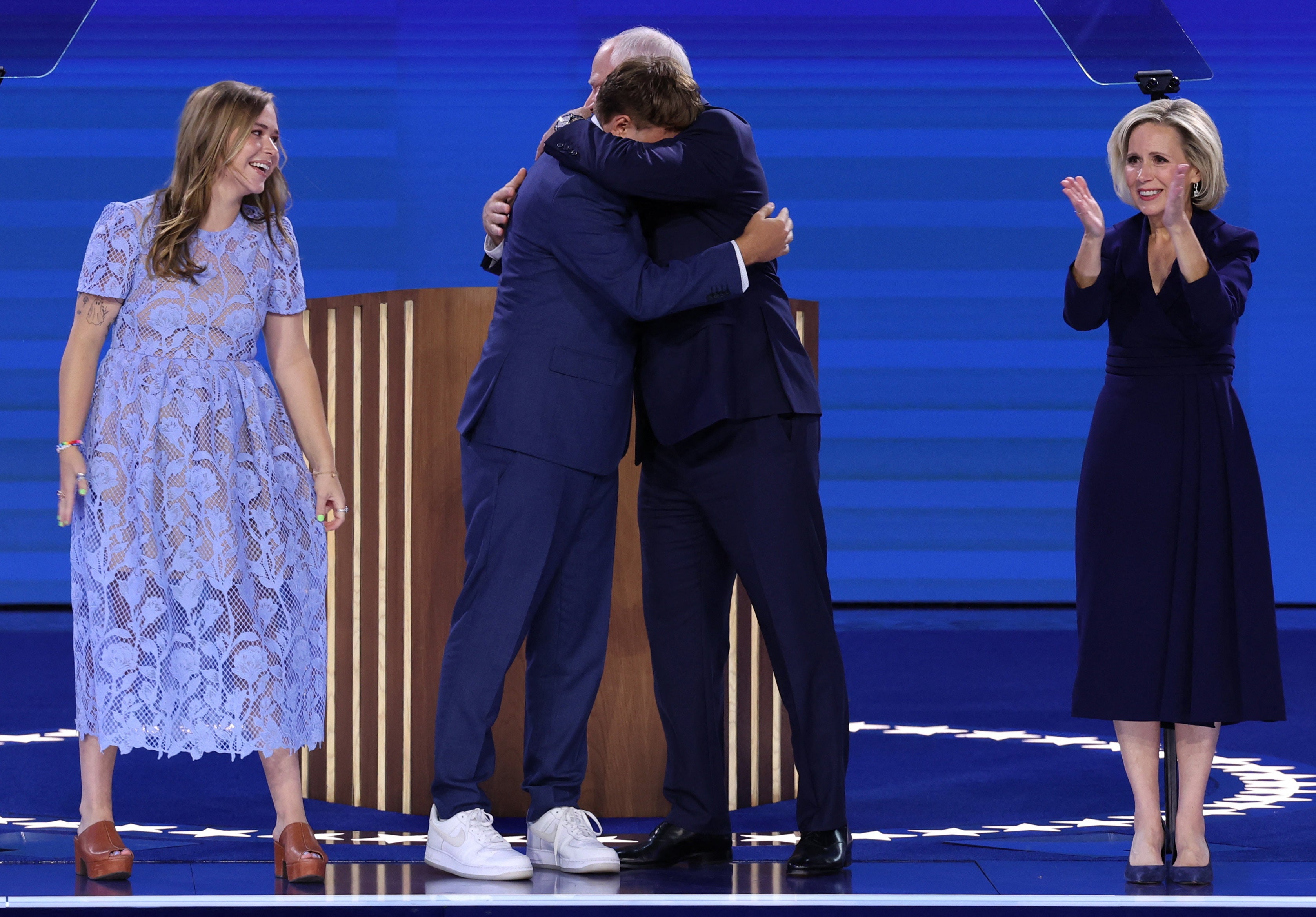 Minnesota Governor Tim Walz hugs his son Gus as his wife Gwen and his daughter Hope look on