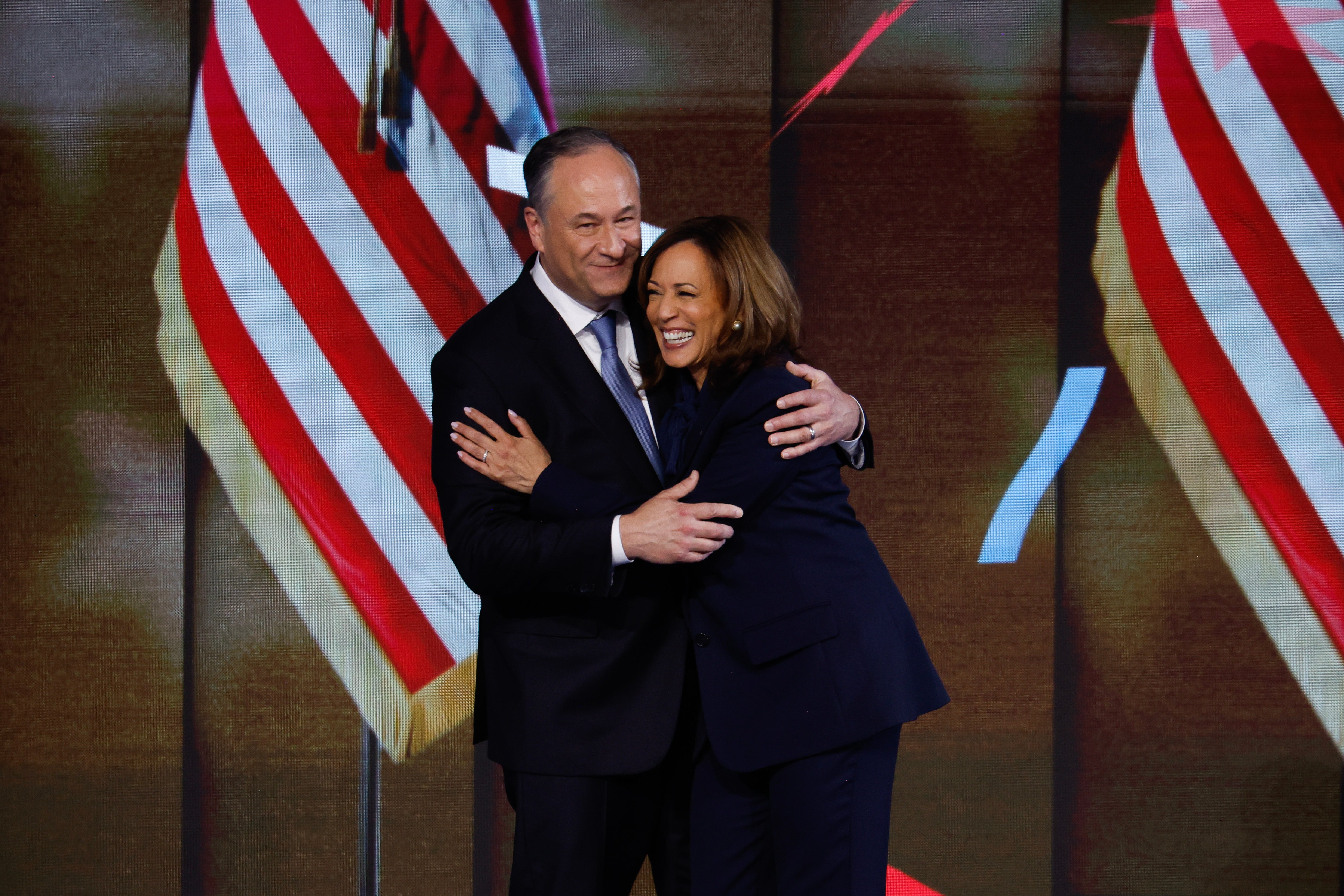 Doug Emhoff embraces Kamala Harris after she accepted the Democratic presidential nomination on August 22. Today is also their wedding anniversary