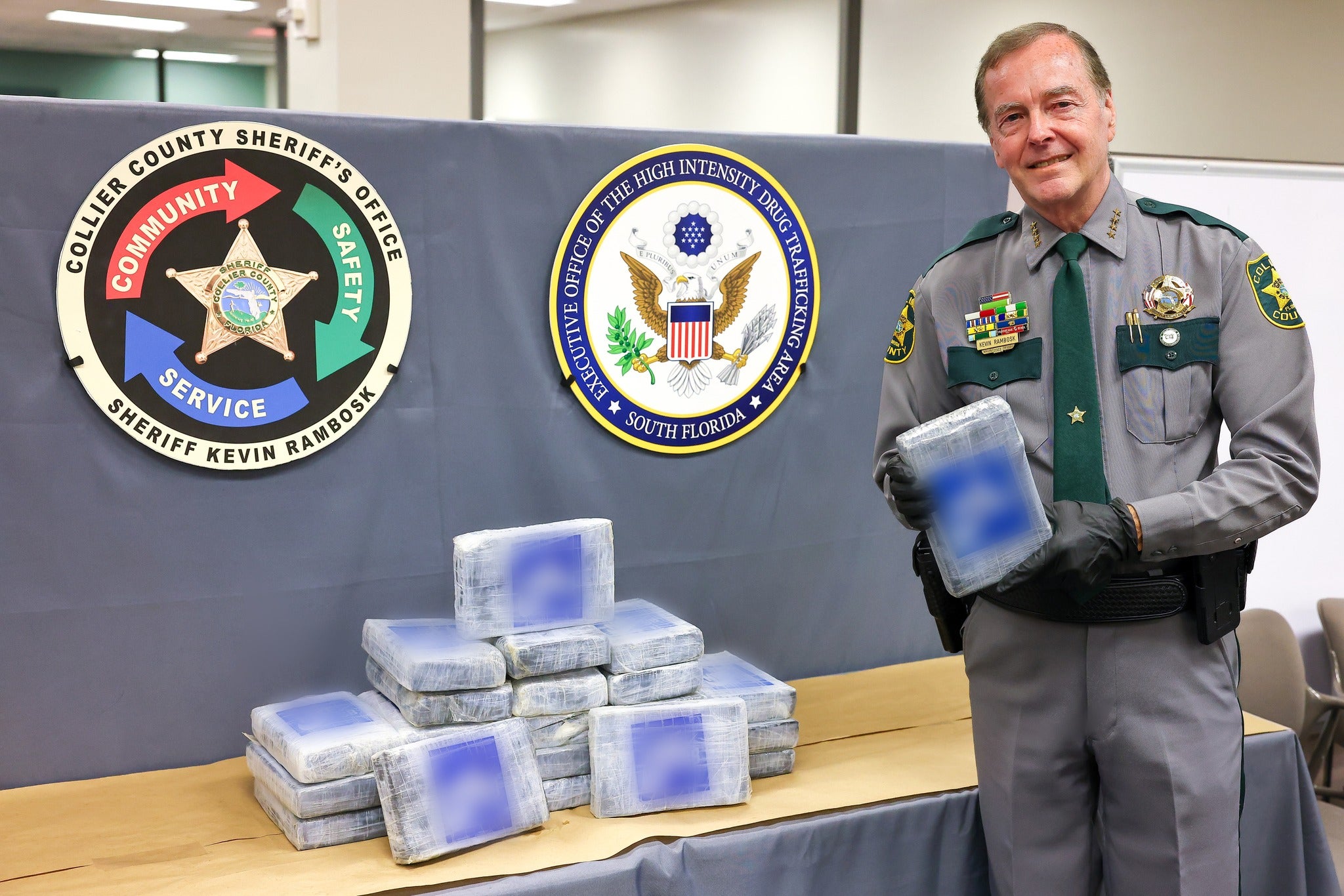 A officer from the Collier County Sheriff’s Office holds up a package of drugs found floating in the Gulf of Mexico on August 12, 2024.