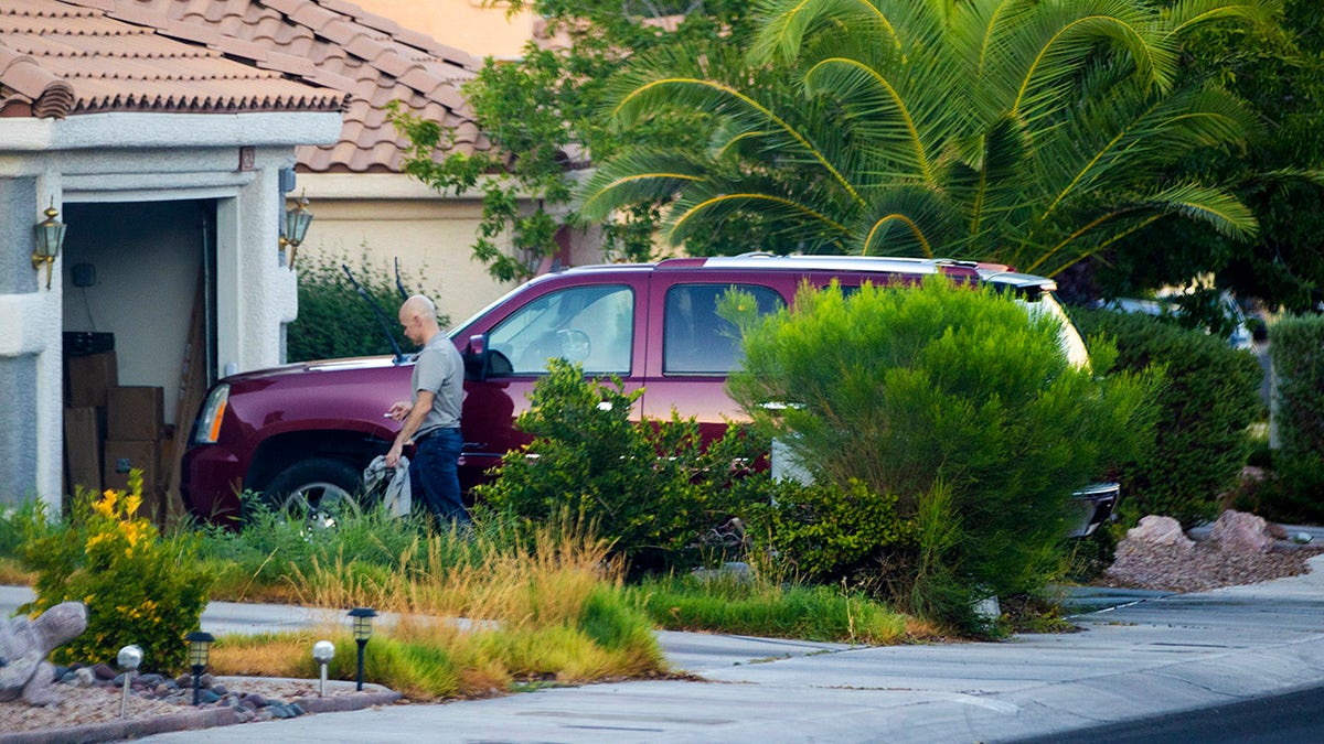 Robert Telles washes his car