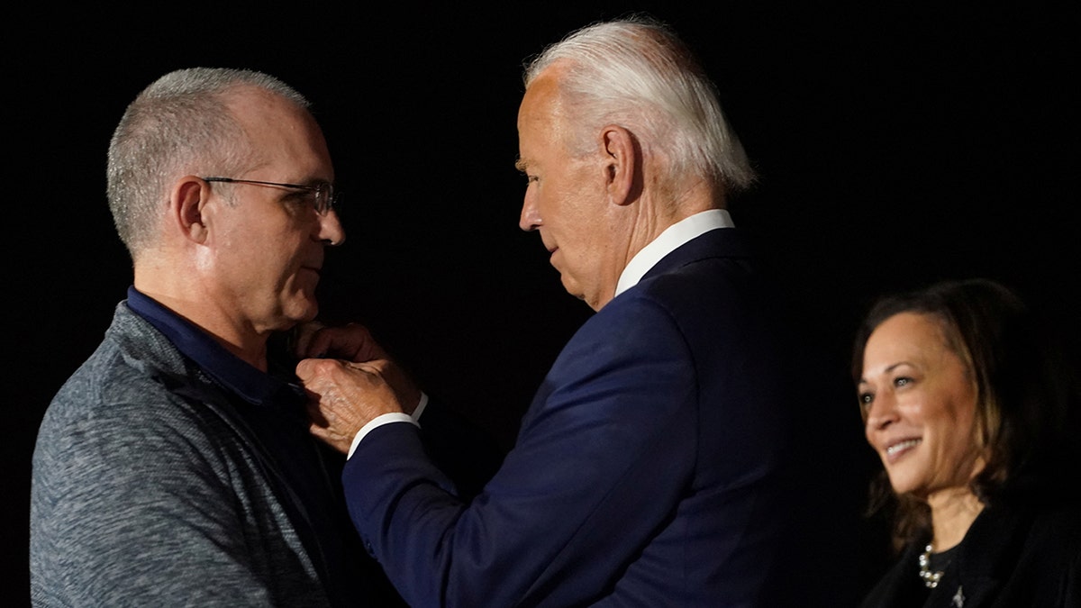 Biden greets Paul Whelan back on U.S. soil