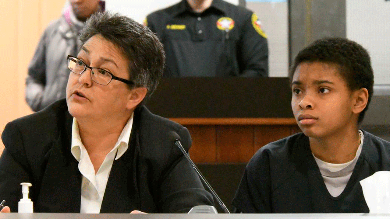 Chrystul Kizer sits with her attorney Larisa Benitez-Morgan in a courthouse