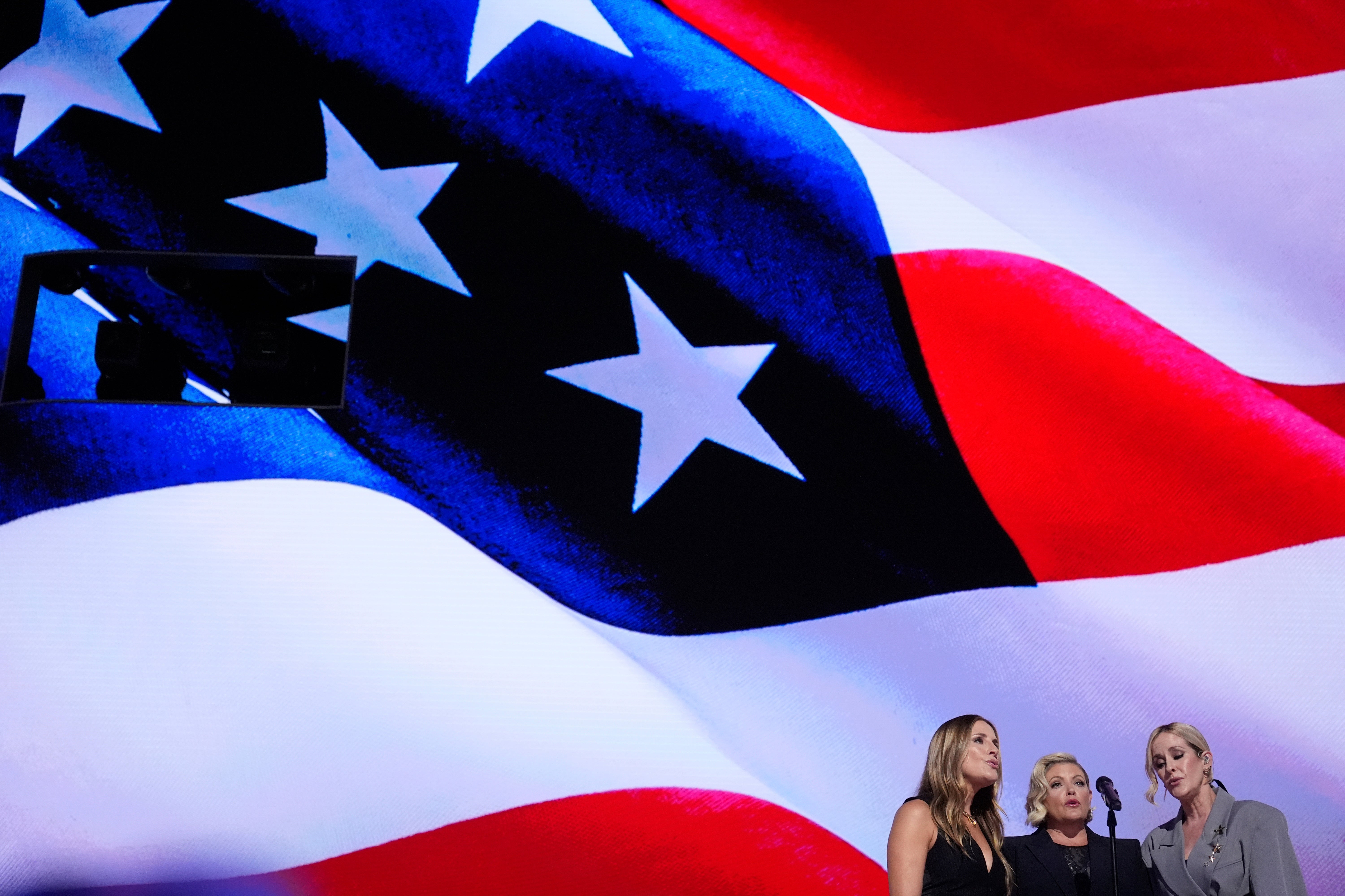 Emily Robison, from left, Natalie es and Martie Maguire, of The Chicks, sing the national anthem during the Democratic National Convention Thursday, Aug. 22, 2024, in Chicago