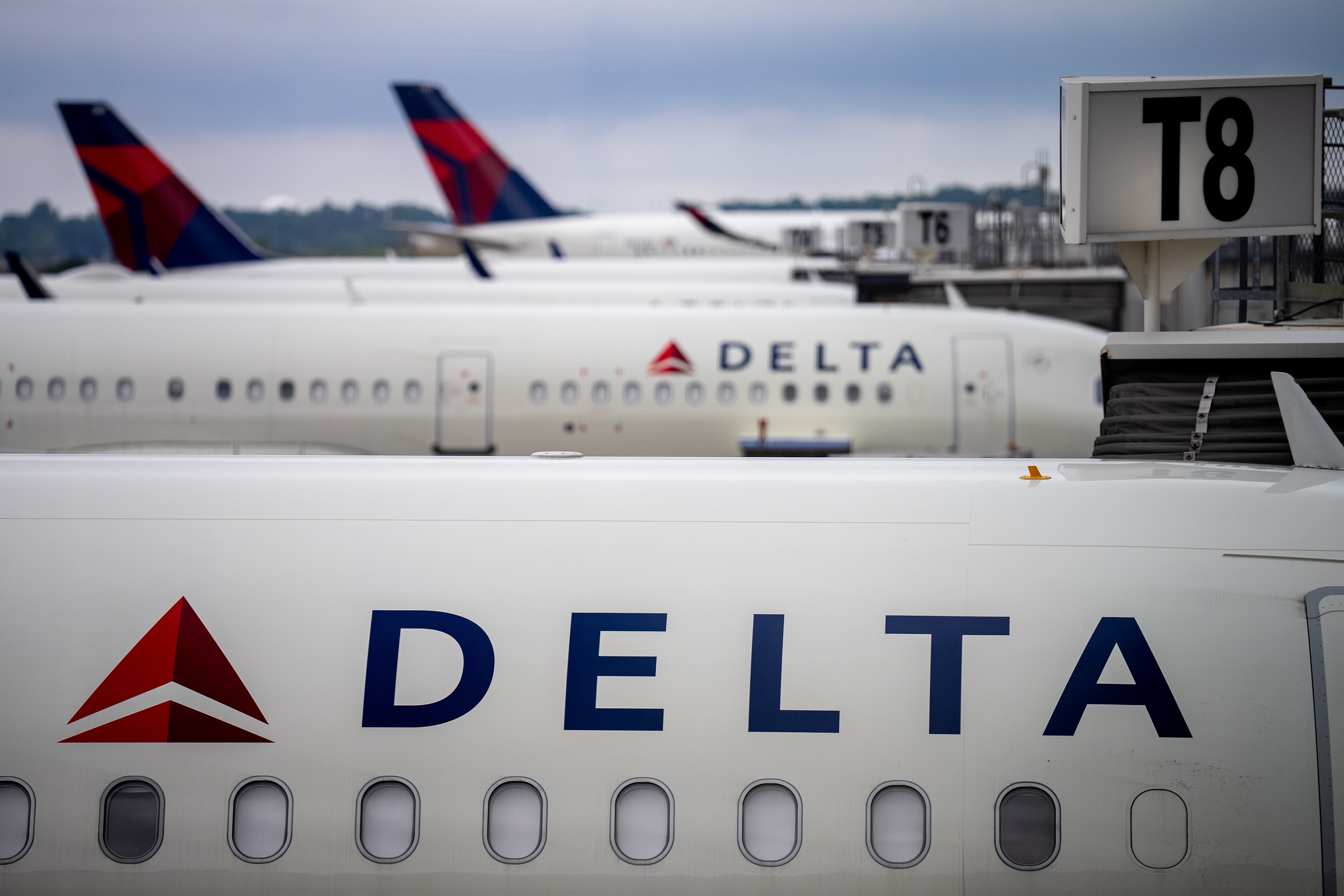 Delta airplanes sit at the Hartsfield-Jackson Atlanta International Airport. A tire exploded on a Delta airplane in a tenance area of the airport, killing two airline employees and injuring a third