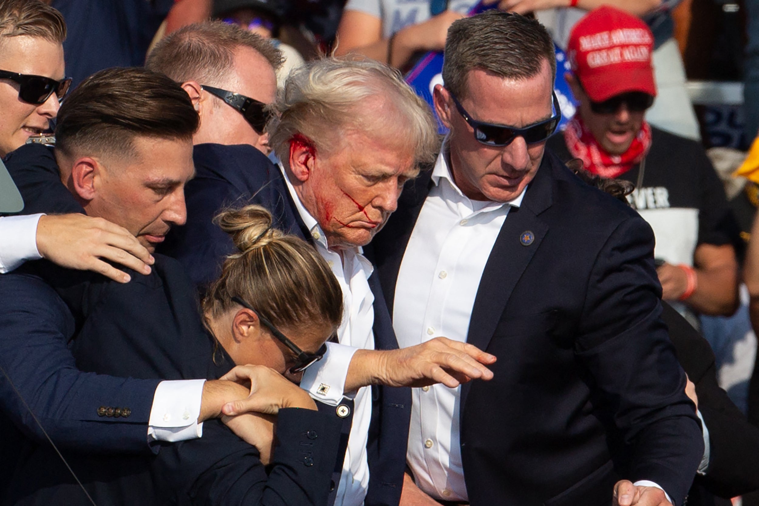 Donald Trump rushed off stage by Secret Service agents after the shooting in Butler, Pennsylvania, on July 13 2024