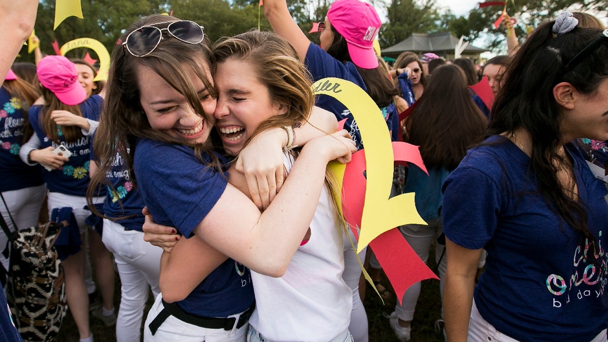 A member of Chi Omega sorority hugs a new member on bid day at George Washington University on the National Mall in Washington, on Tuesday, October 6, 2015. 