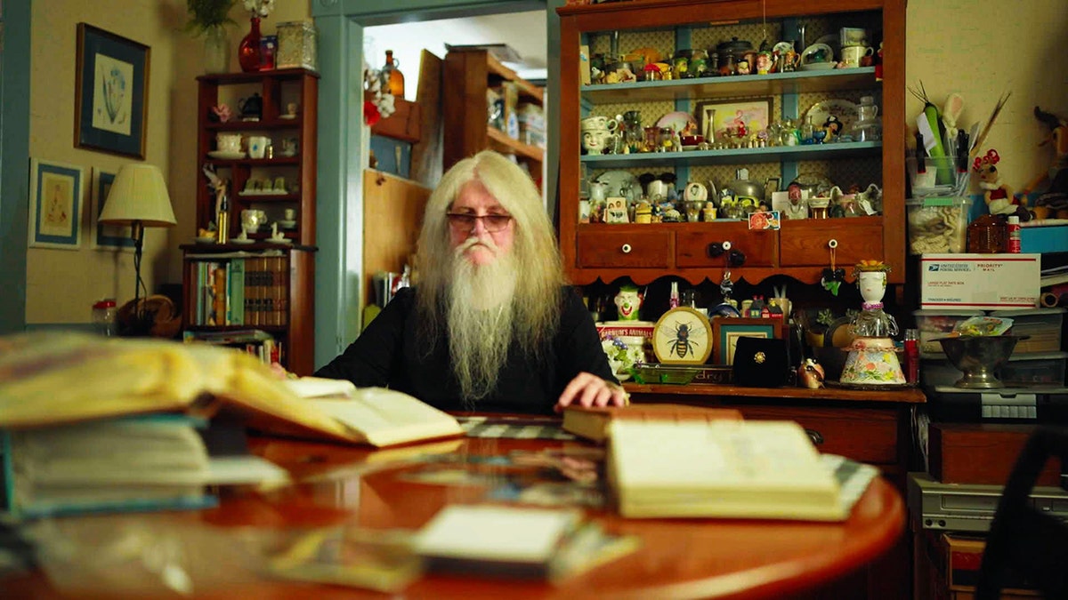 Jack Truitt at home reading books.