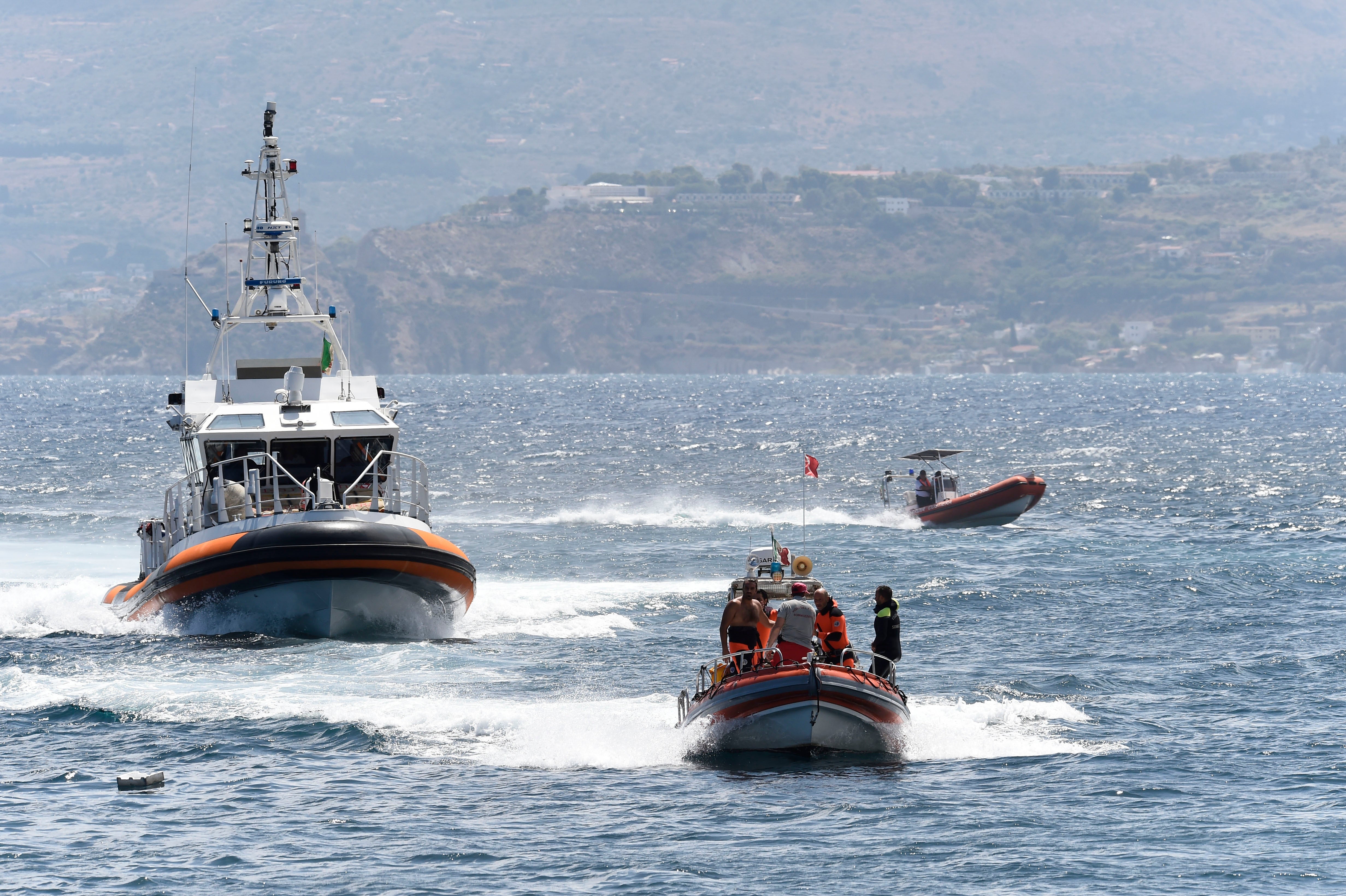 Emergency services at the scene of the search for a missing boat, in Porticello, southern Italy