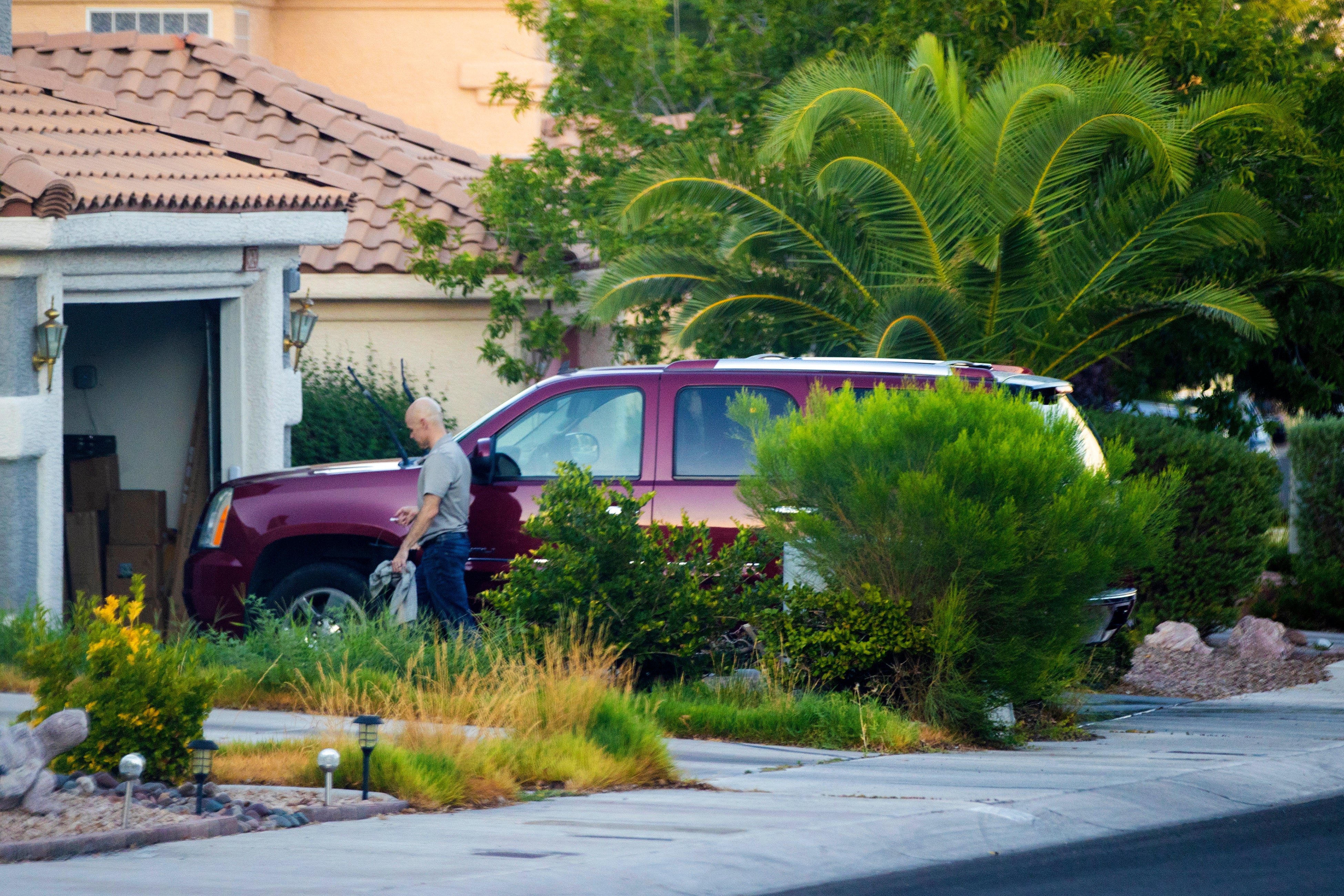 Former Clark County Public Administrator Robert Telles washes his car outside his home in September 2022 before being arrested for German’s killing