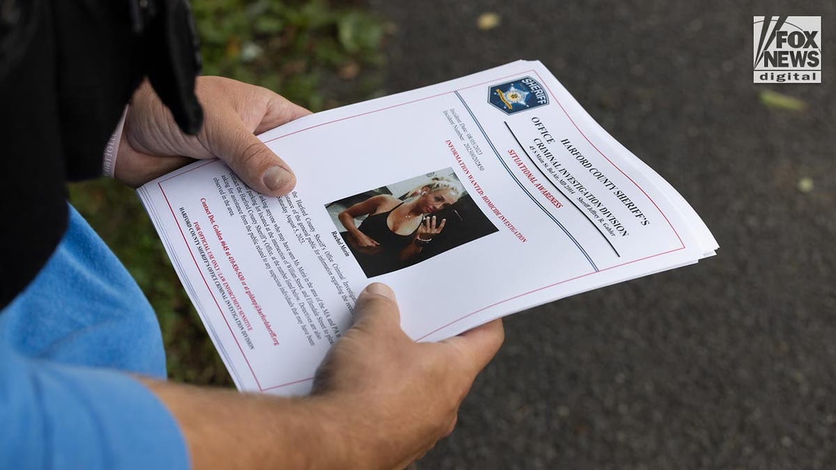 A close up of hands holding papers