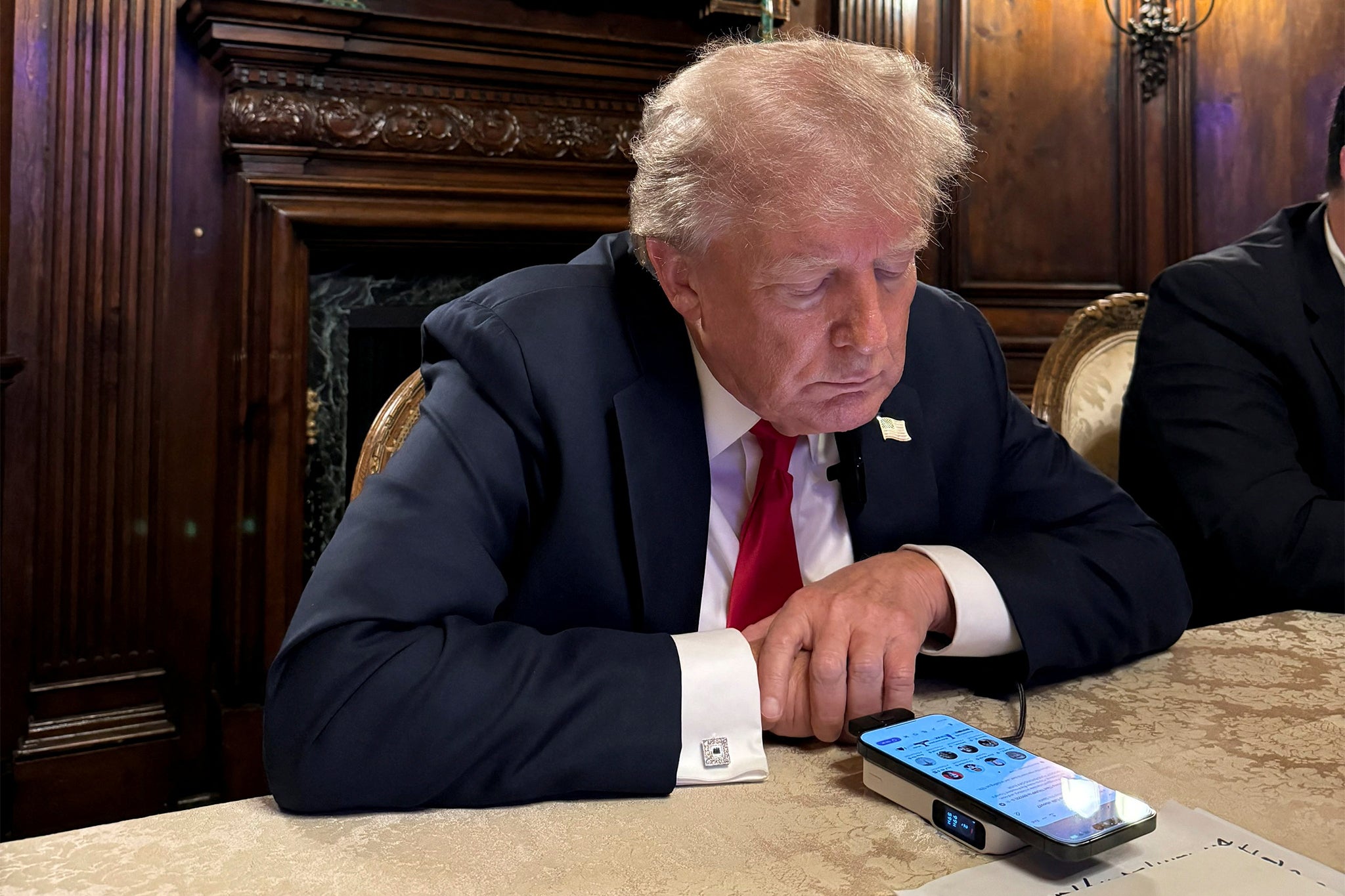 Donald Trump is pictured participating in a live Twitter Spaces interview with CEO Elon Musk