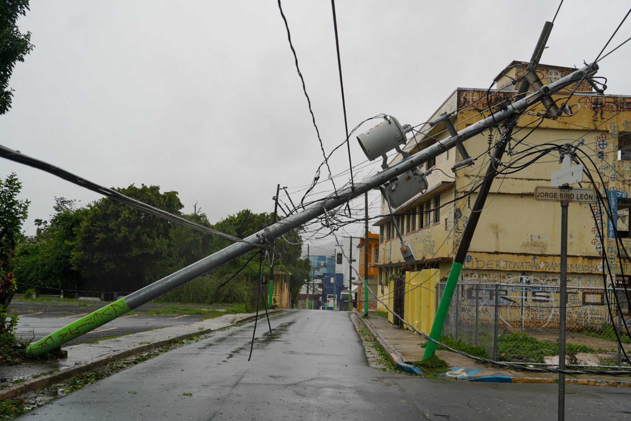 Broken electricity lines are seen above homes after Ernesto hit Fajardo, Puerto Rico