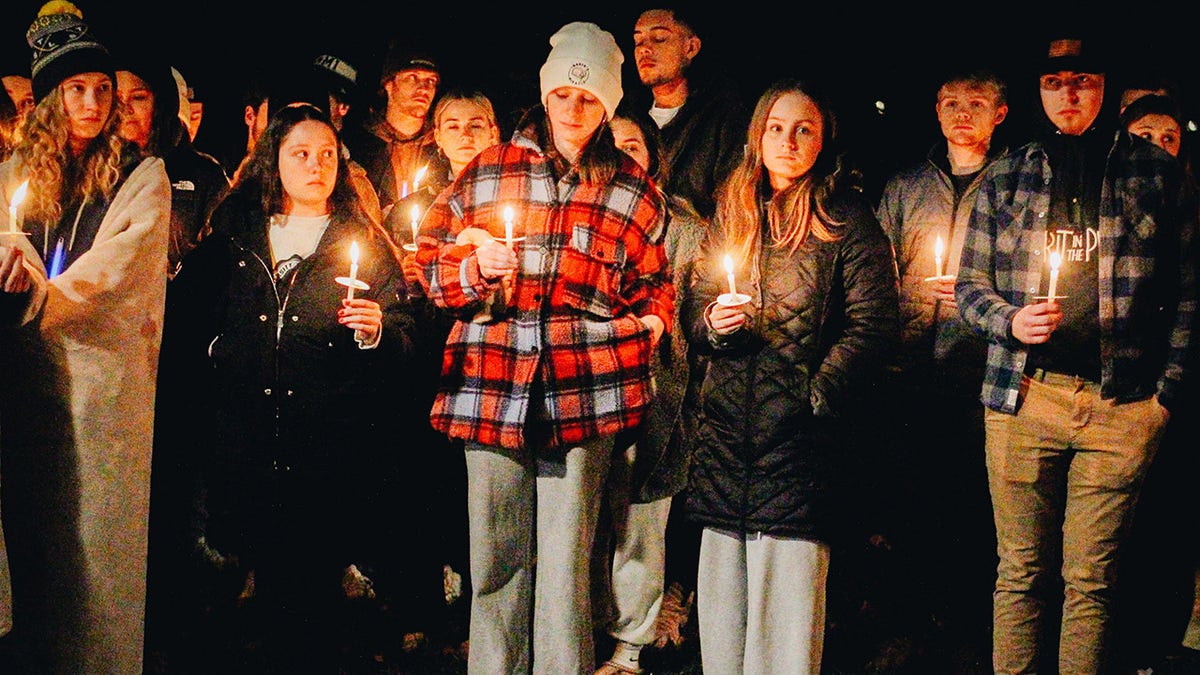 Students gathering together to light candles.