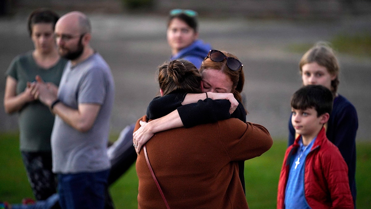 Lewiston, Maine shooting victims' families hug