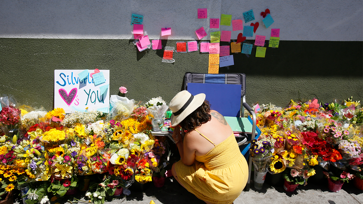 A makeshift memorial of flowers, candles and notes