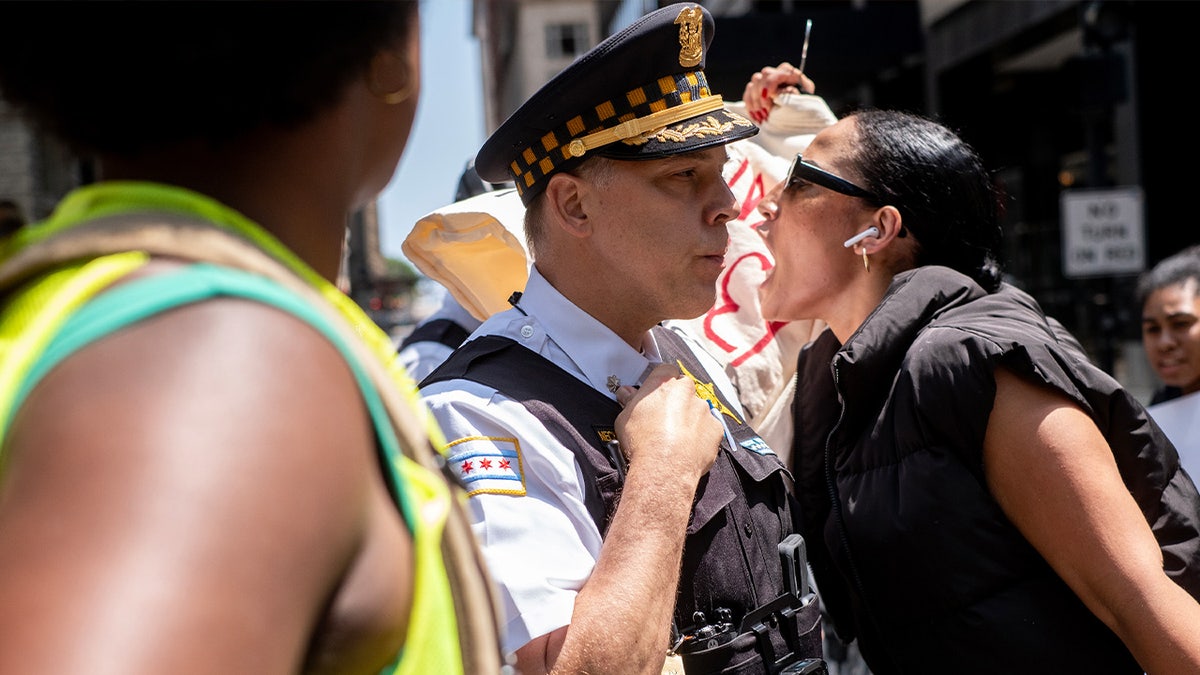 Demonstrator yells at police officer at rally