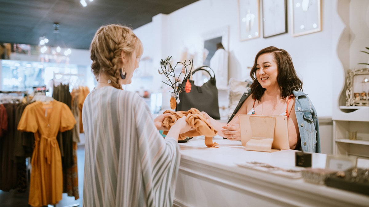 Woman checking out at a boutique 