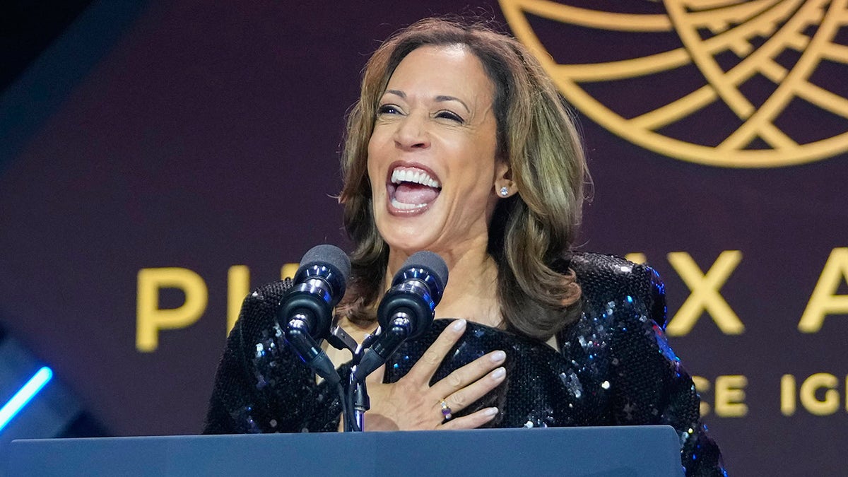 Harris laughs on stage at Congressional Black Caucus dinner