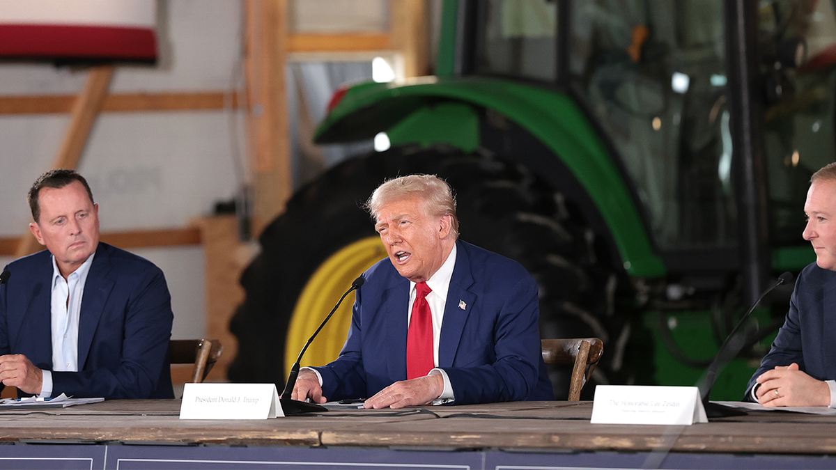 Donald Trump at center at table, speaking