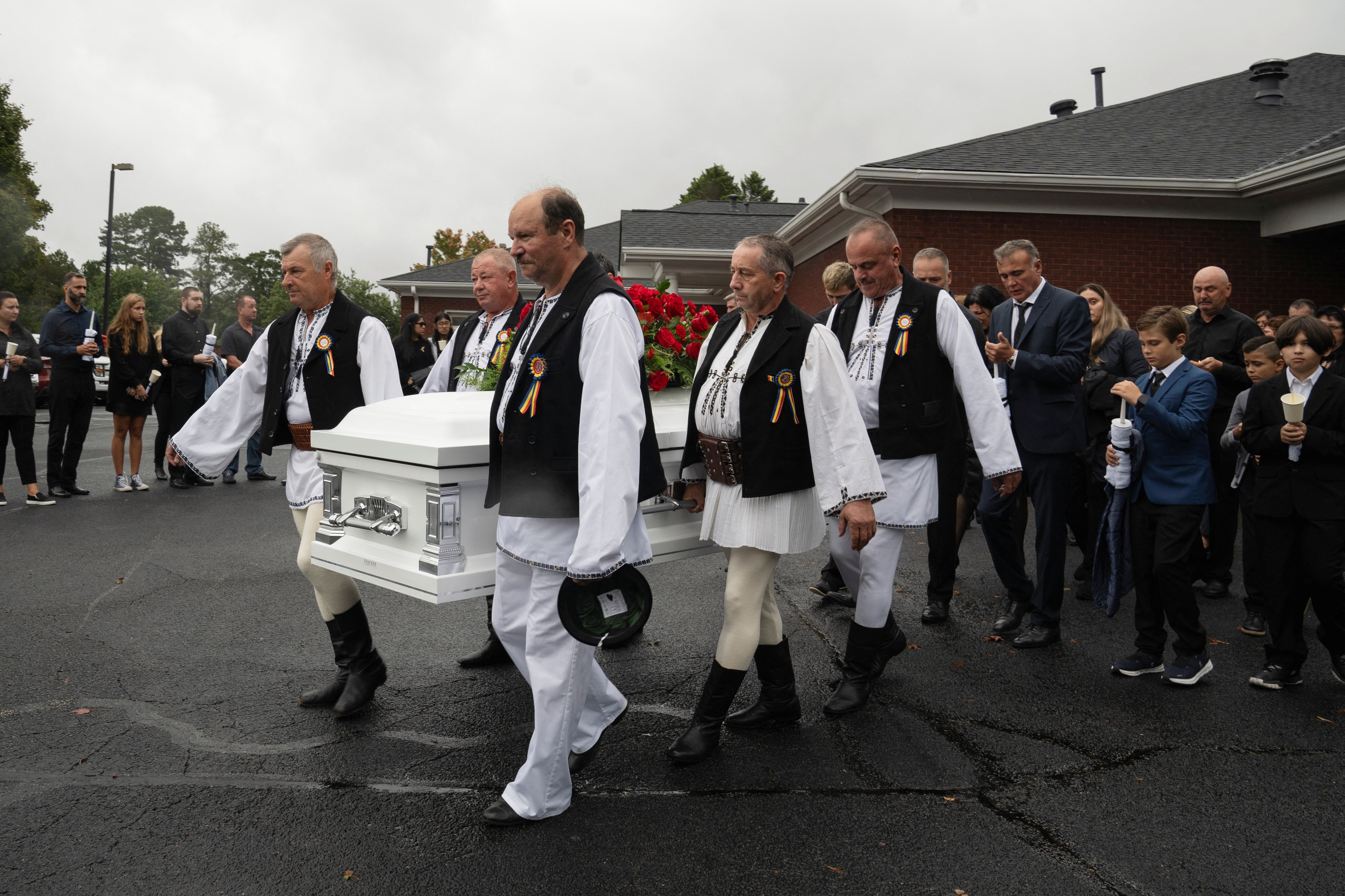 Mourners gathered at the funeral of teacher Ana Christina Irimie, who was killed in the school shooting, which was held in Georgia on Saturday