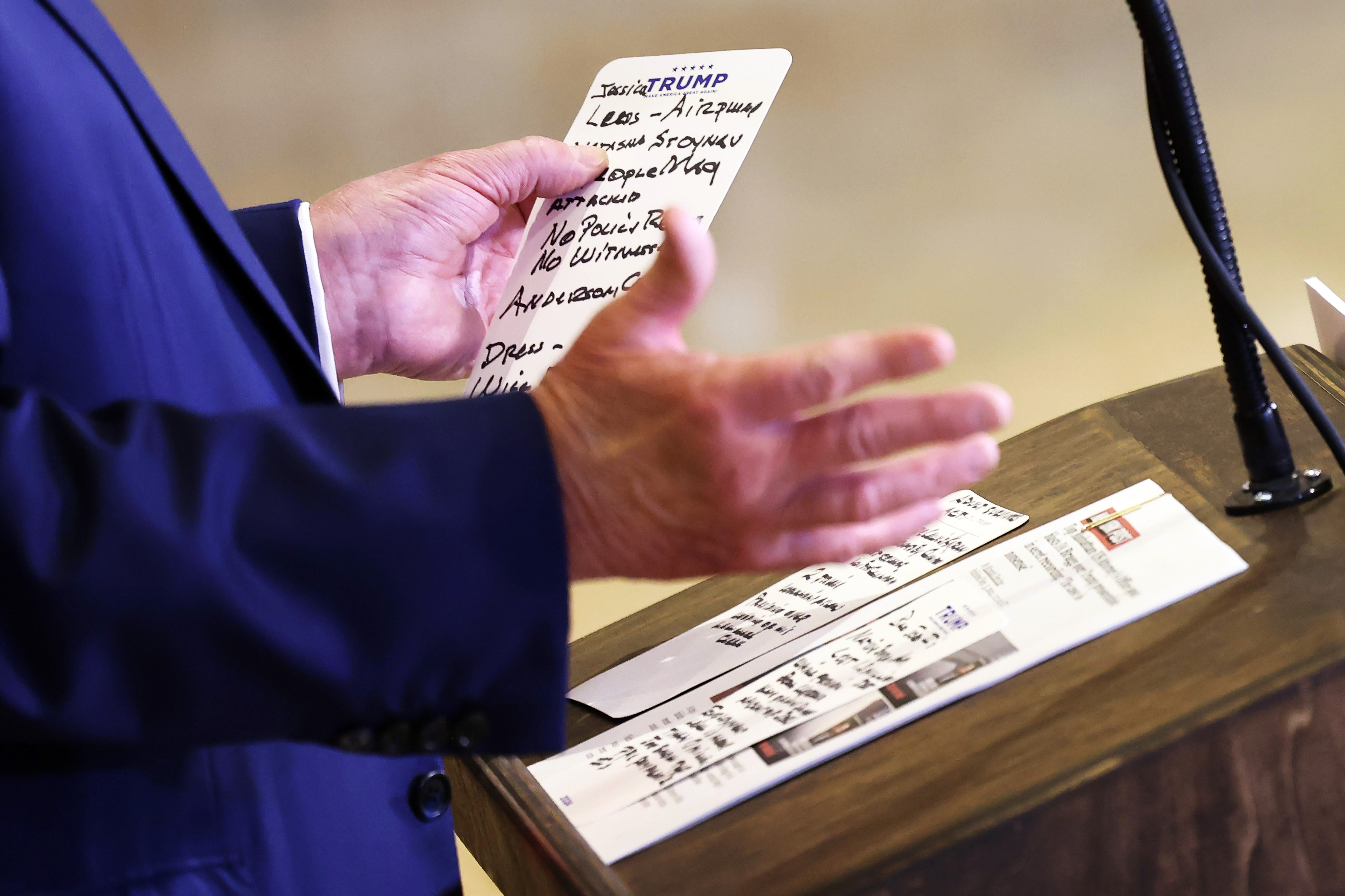 Donald Trump holds notes for his remarks at Trump Tower on September 6