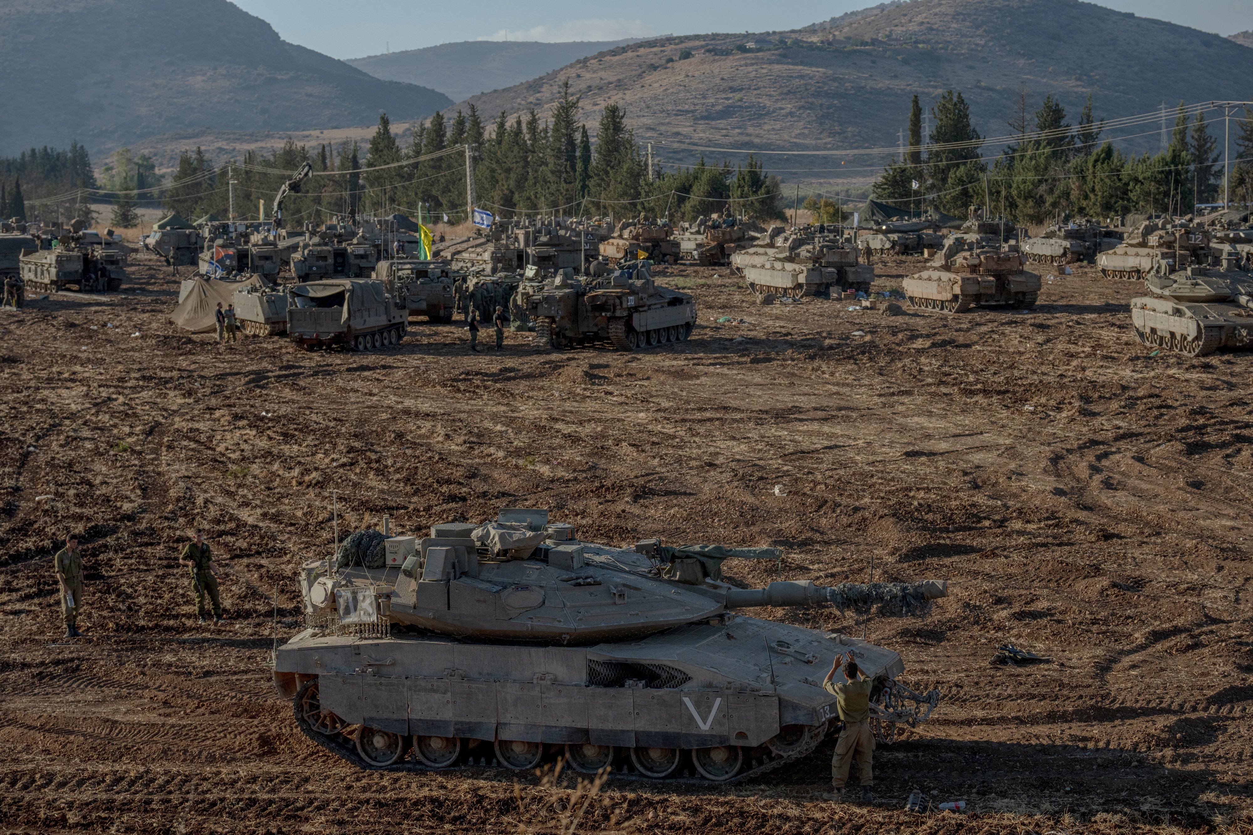 Israeli tanks and APC's gather by the Israeli - Lebanese border on September 30, 2024.