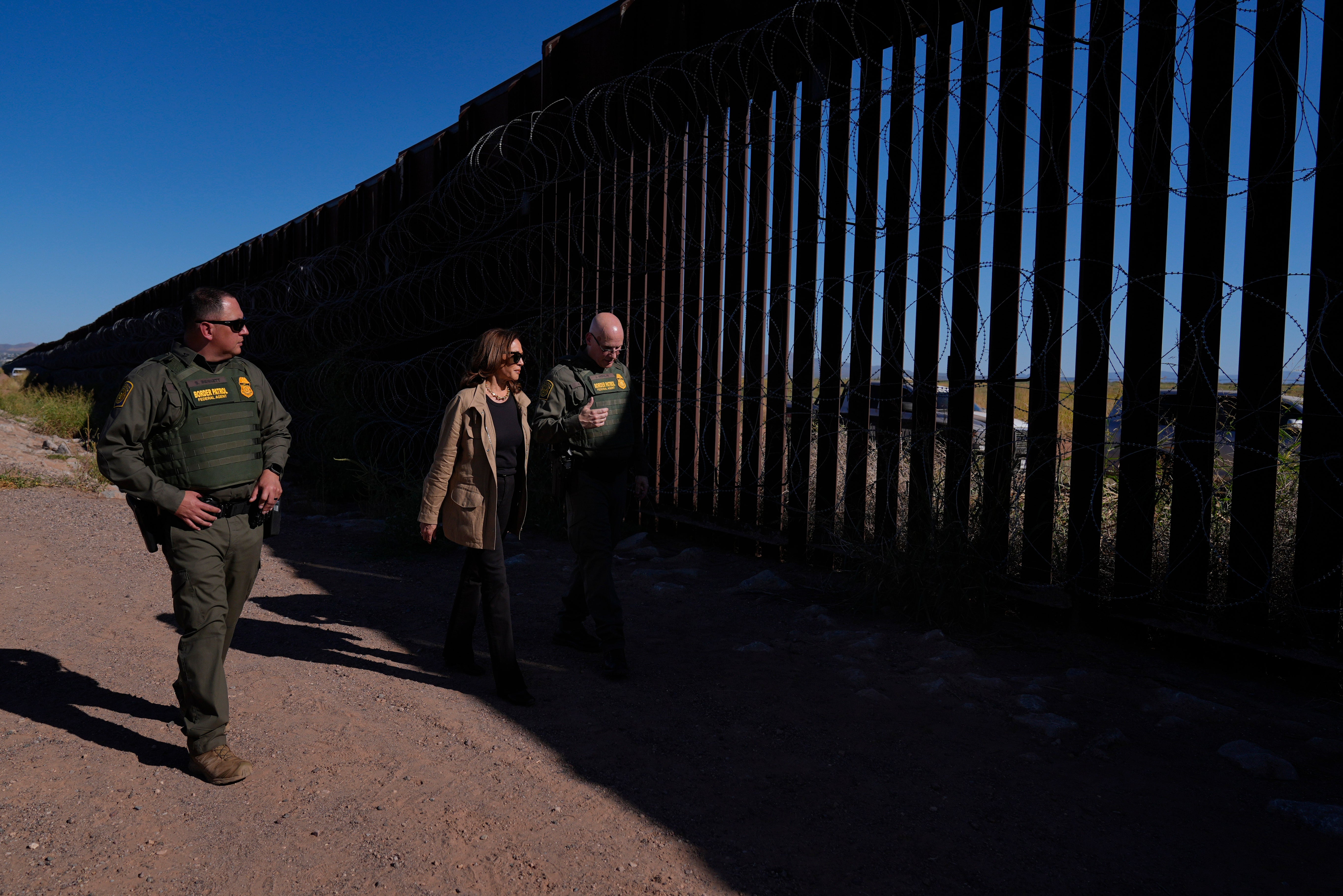 Democratic presidential nominee Vice President Kamala Harris talks with John Modlin, the chief patrol agent for the Tucson Sector of the U.S. Border Patrol, right, and Blaine Bennett, the U.S. Border Patrol Douglas Station border patrol agent in charge, as she visits the U.S. border with Mexico in Douglas, Ariz., Friday, Sept. 27, 2024