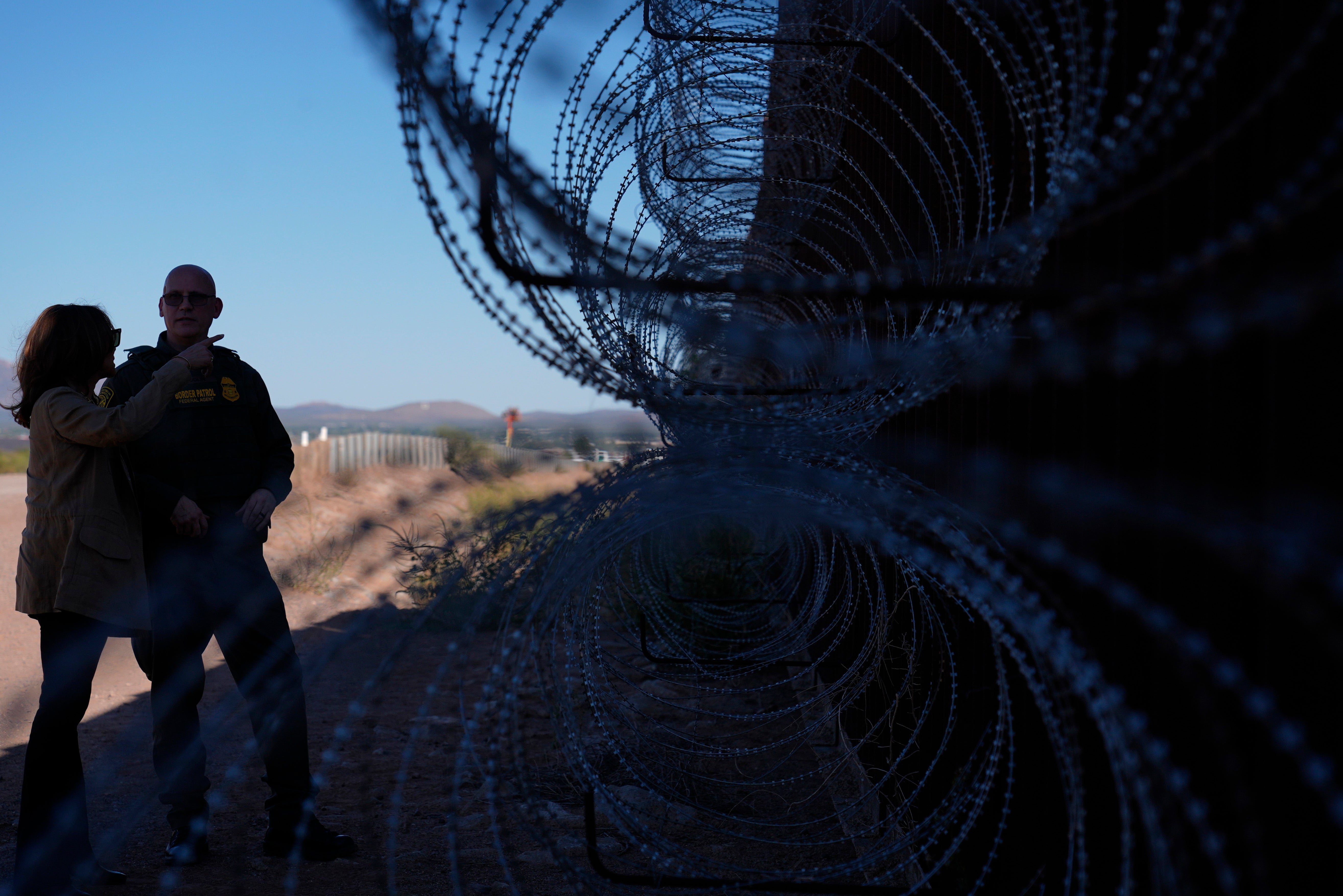 Democratic presidential nominee Vice President Kamala Harris talks with John Modlin, the chief patrol agent for the Tucson Sector of the U.S. Border Patrol, right, as she visits the U.S. border with Mexico in Douglas, Ariz., Friday, Sept. 27, 2024