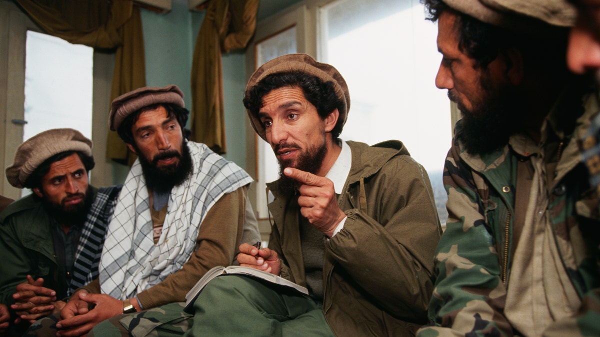 Commander Ahmed Shah Massoud, center, gives orders to his officers in his headquarters in Charikar, Afghanistan, during peace negotiations with the communist government, after the departure of Soviet soldiers.