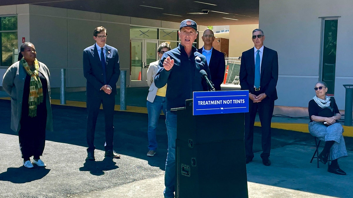 Gov. Newsom at lectern outdoors