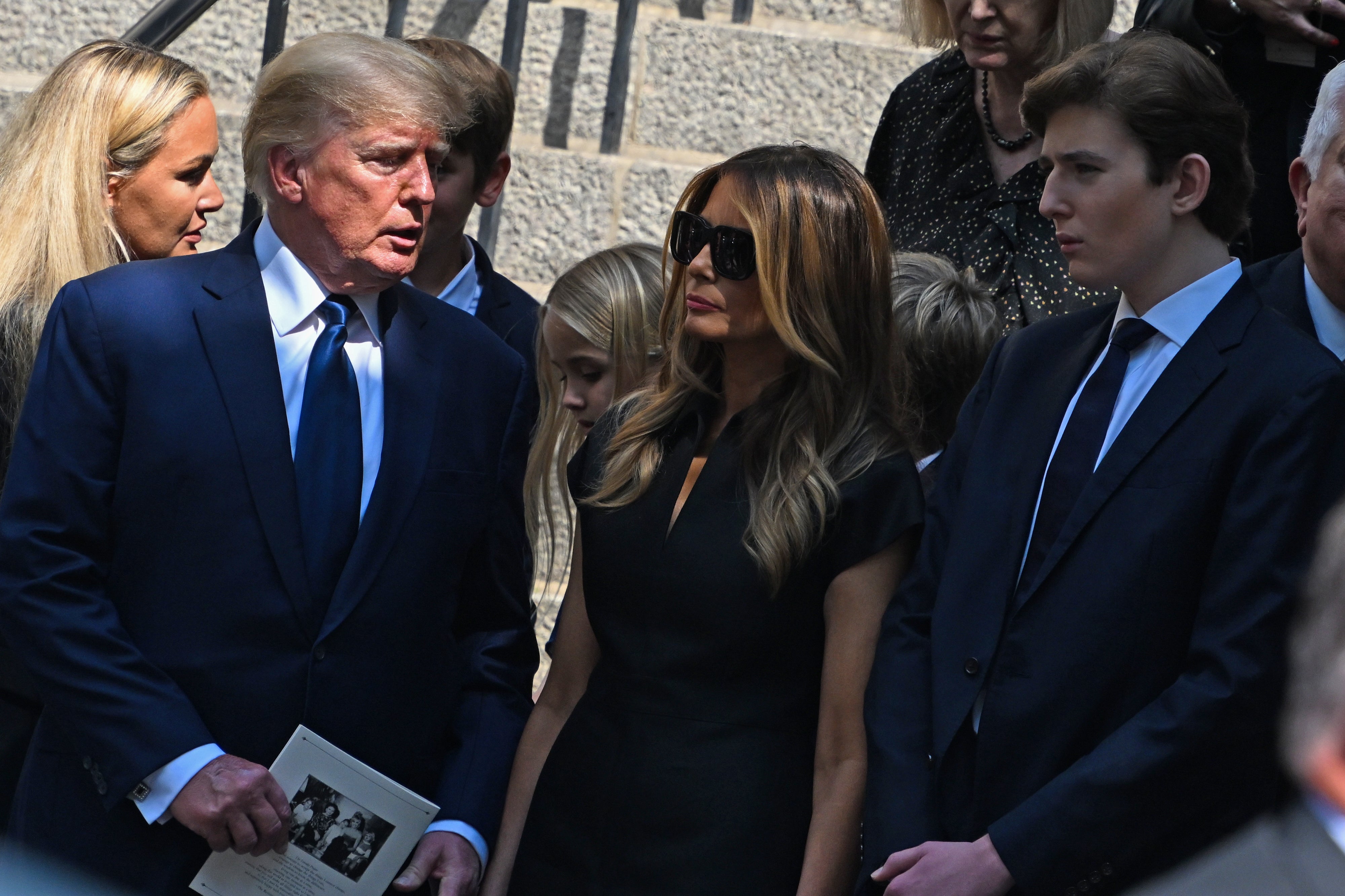 Former President Donald J. Trump, Melania Trump and Barron Trump exit the funeral of Ivana Trump at St. Vincent Ferrer Roman Catholic Church on July 20, 2022, in New York City. Trump now says he worries for his family’s safety after two assassination attempts