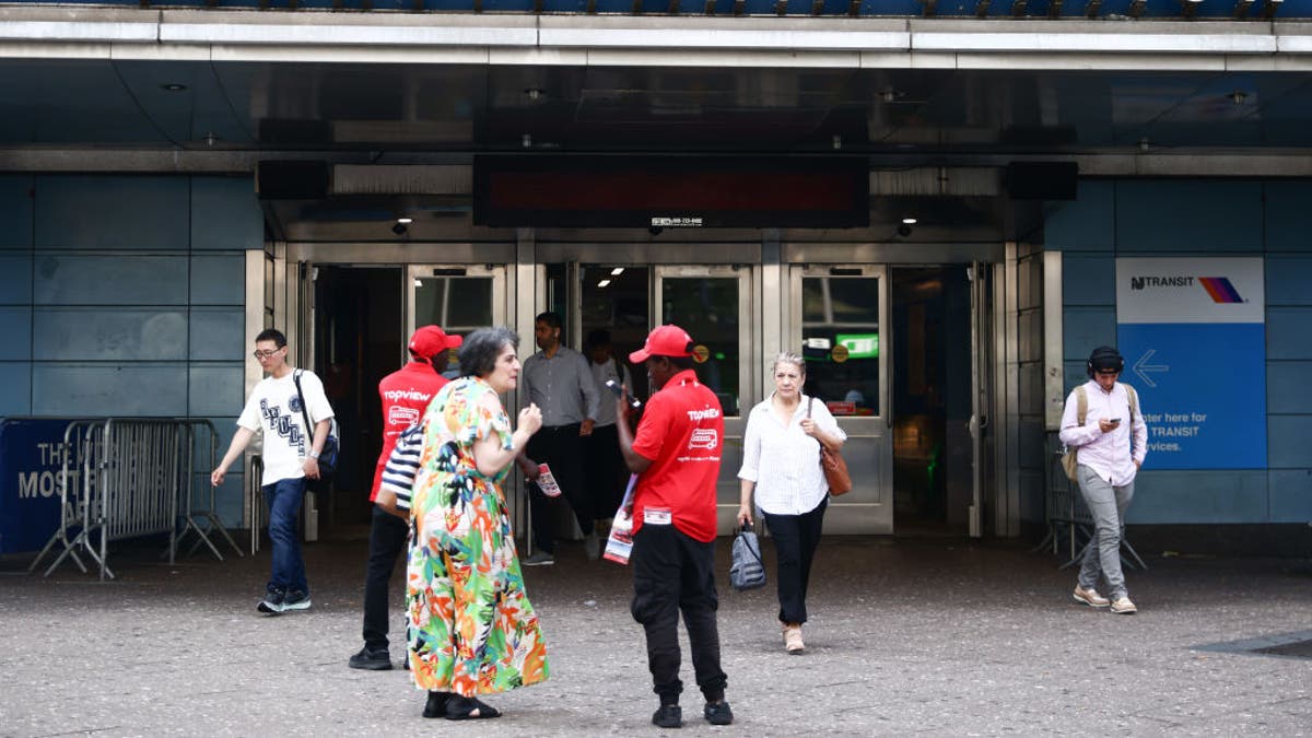 Penn Station seen from exterior with a few people coming and going