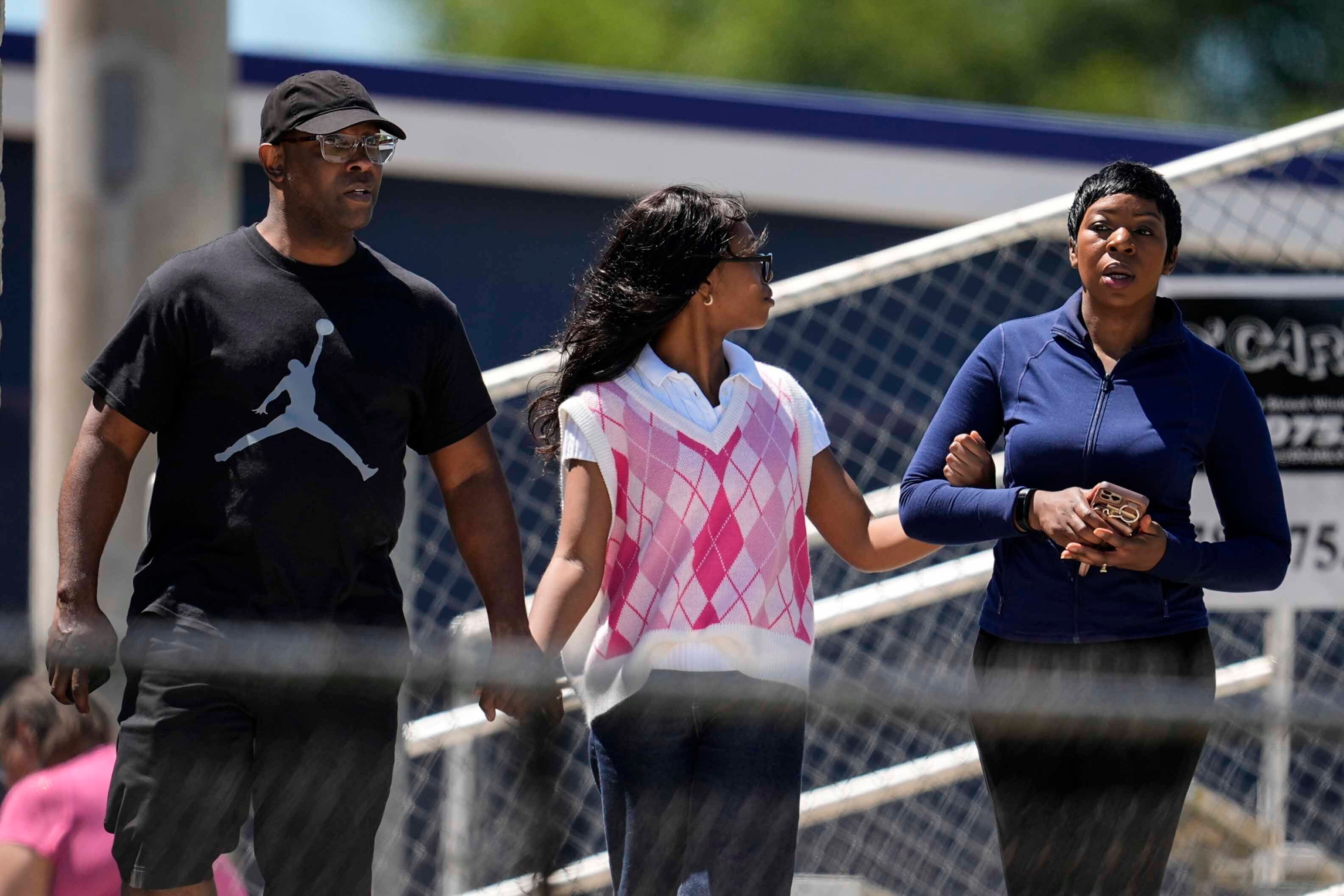 Parents and their child walk out of Apalachee High School on Wednesday. Two students and two teachers are dead following a deadly shooting at the rural high school, but police have not released a motive in the case.