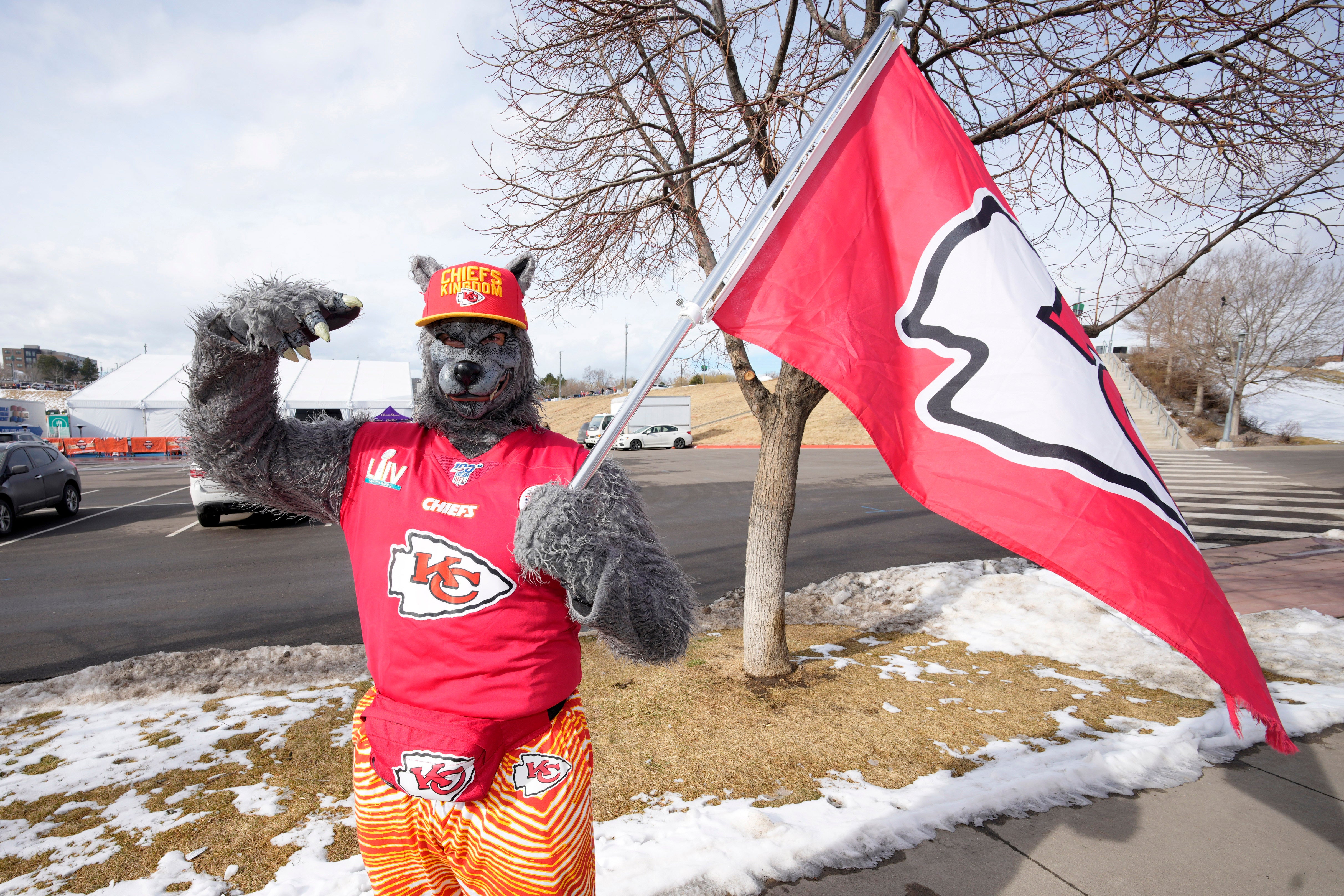 ChiefsAholic, also known as Xaviar Babudar, poses for photos while walking toward Empower Field at Mile High before a Denver Broncos and Kansas City Chiefs game on January 8, 2022