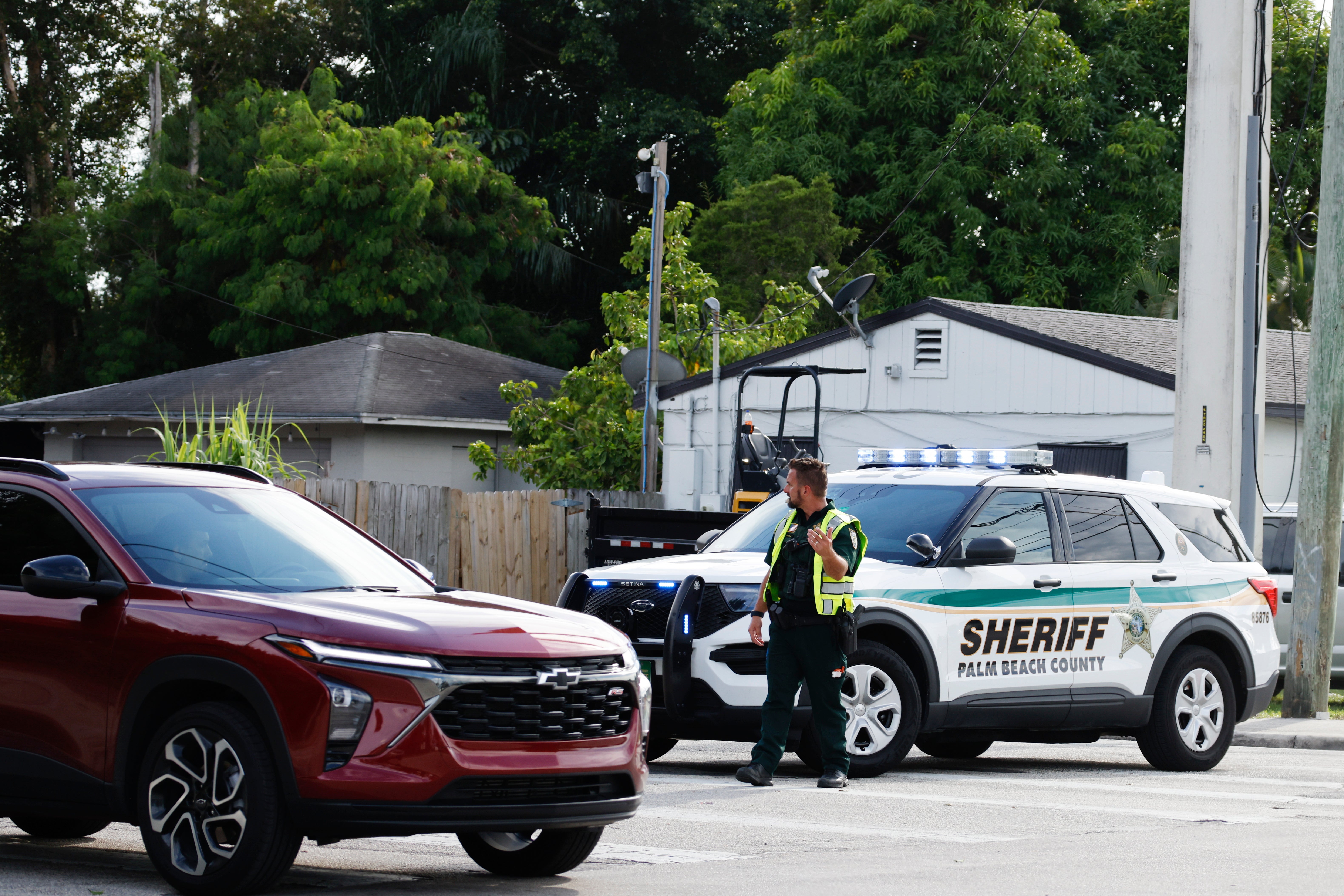 A police officer directs traffic near Trump International Golf Club after the apparent assassination attempt of Republican presidential nominee former President Donald Trump in West Palm Beach, Fla., Sunday, Sept. 15, 2024