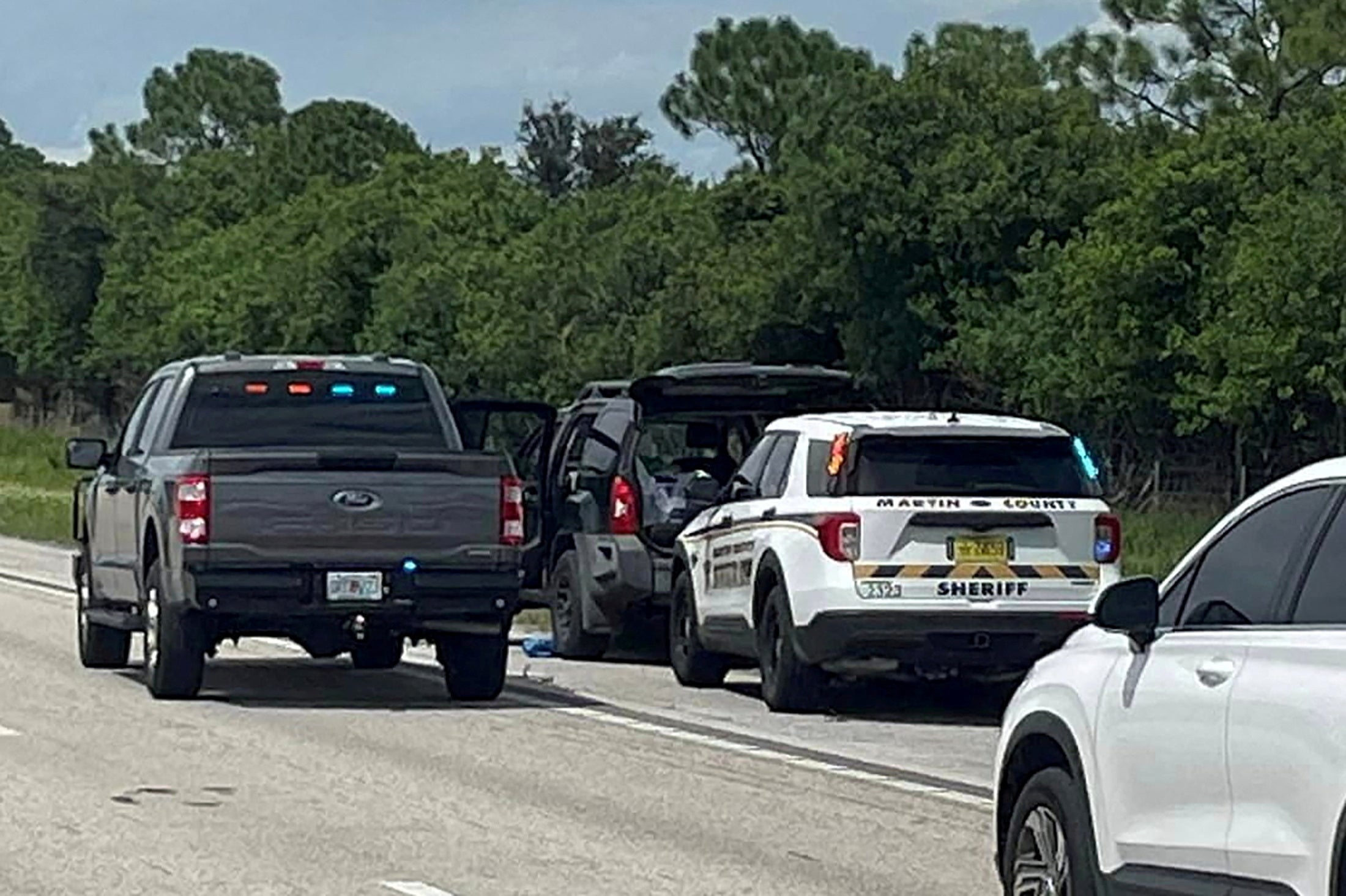 Police vehicles stop a car, following reports of multiple shots fired near the golf course of Republican presidential candidate Donald Trump, near Palm City, Florida, U.S., September 15, 2024