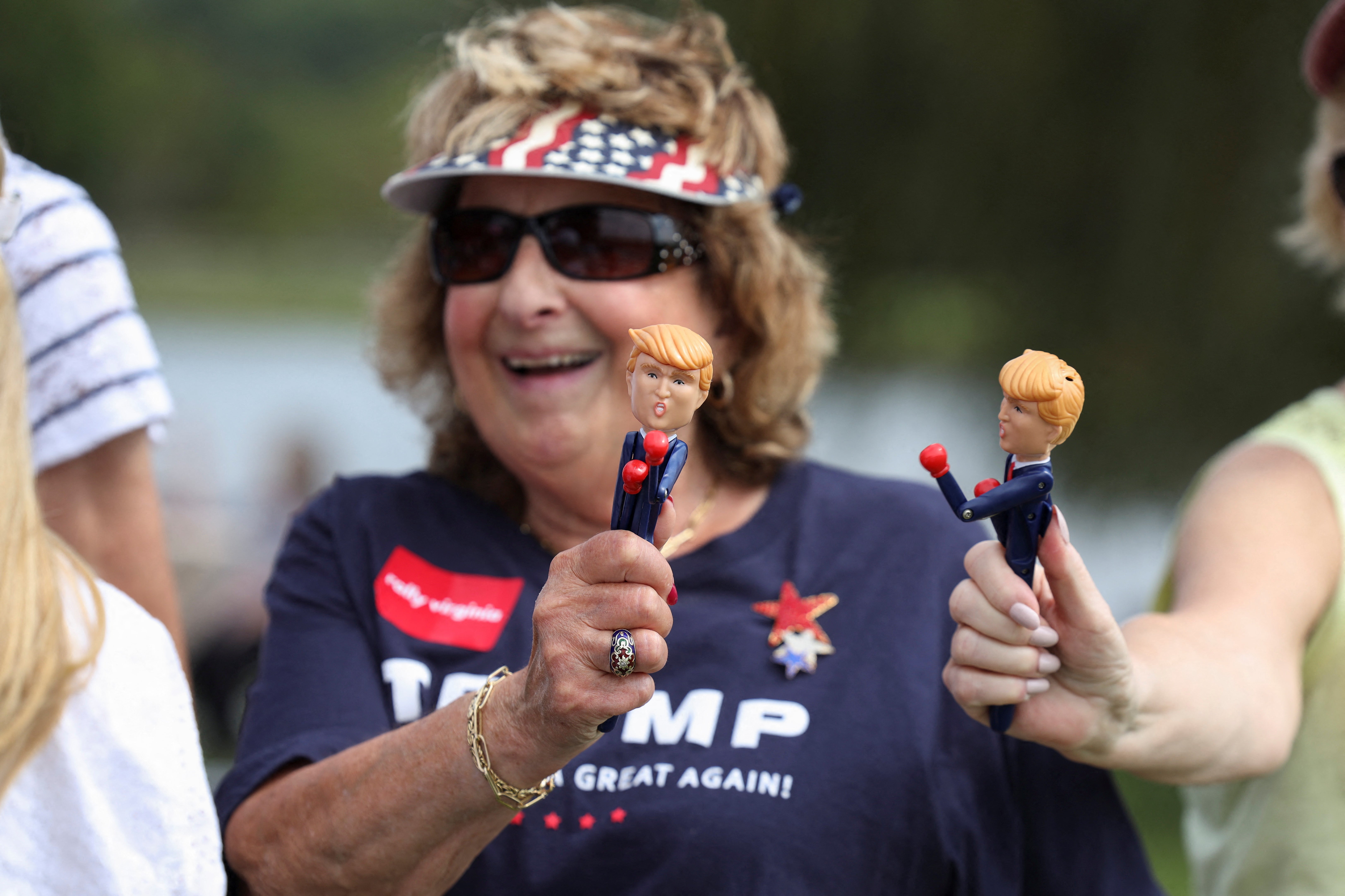 A Trump supporter holds a figurine of the former president at his Wilmington, North Carolina, rally on Saturday. Some have wondered if Trump fatigue is setting in for some voters