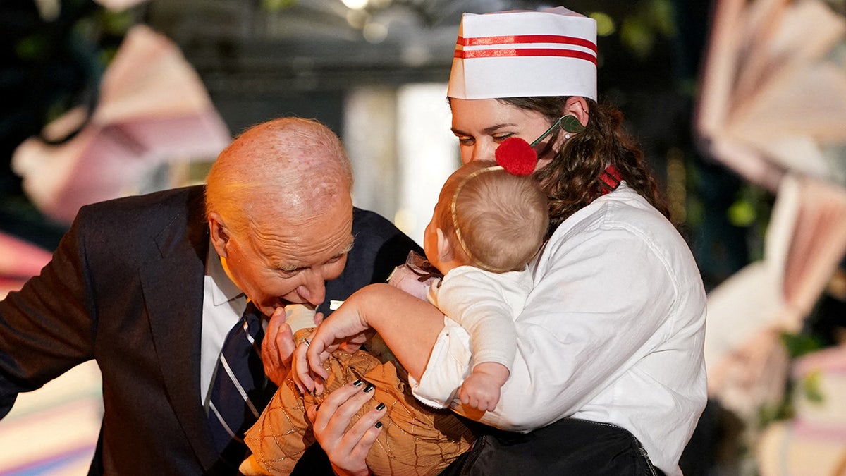 Biden bites a child in a halloween costume