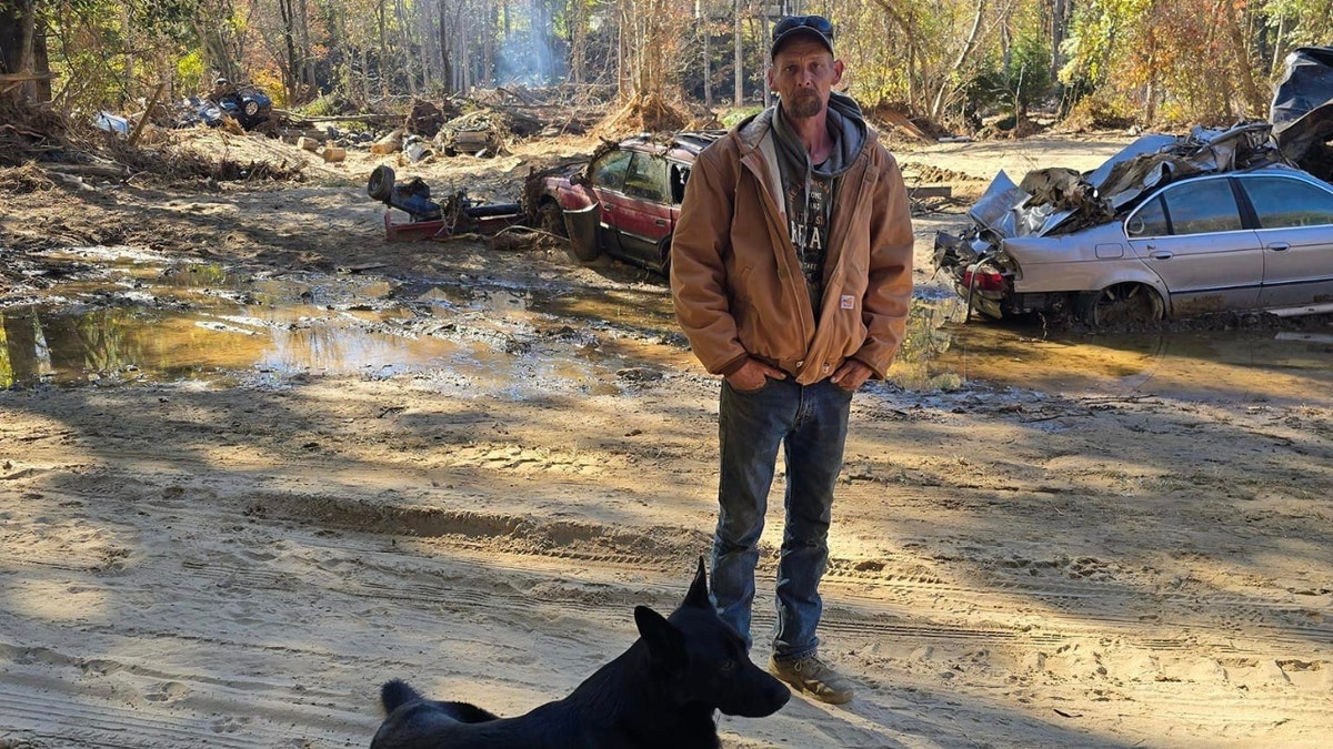 Chris Griffin poses next to his dog